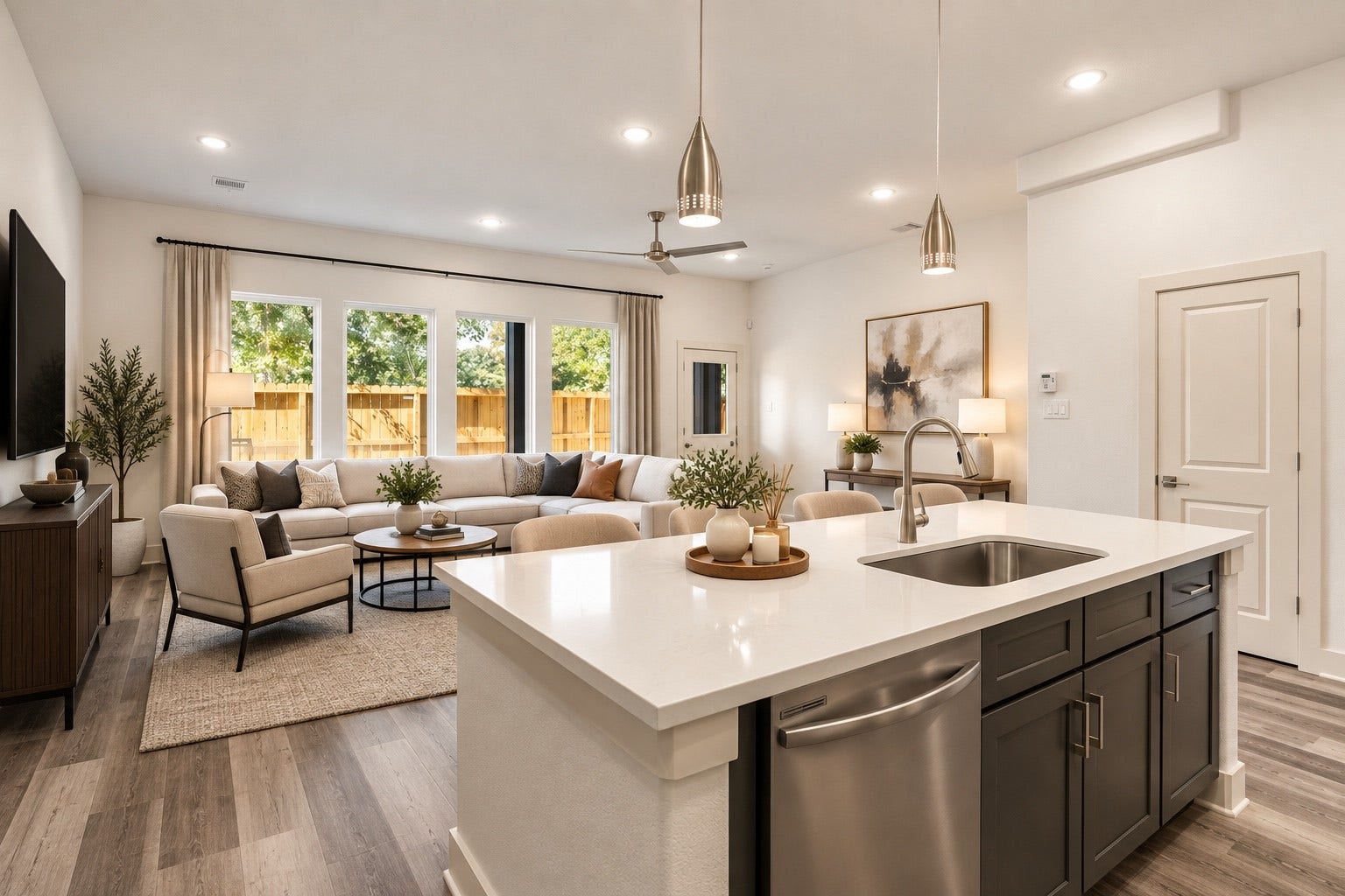 5629 Malmedy Road, Houston, TX 77033 Spacious open-concept living area with modern kitchen, featuring a large island, stylish pendant lighting, and ample natural light from expansive windows.
*photo is virtually staged*