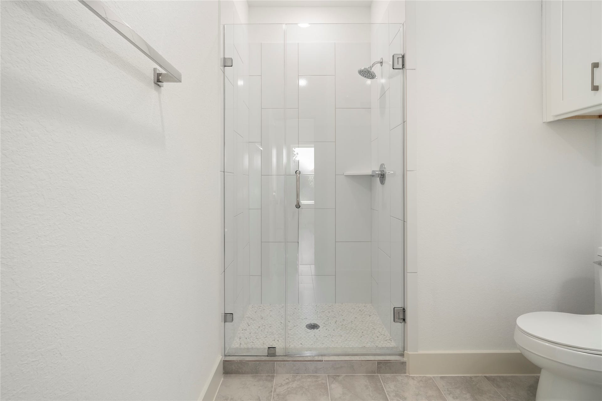 5629 Malmedy Road, Houston, TX 77033 Modern bathroom featuring a sleek glass-enclosed shower with stylish tilework and contemporary fixtures.
