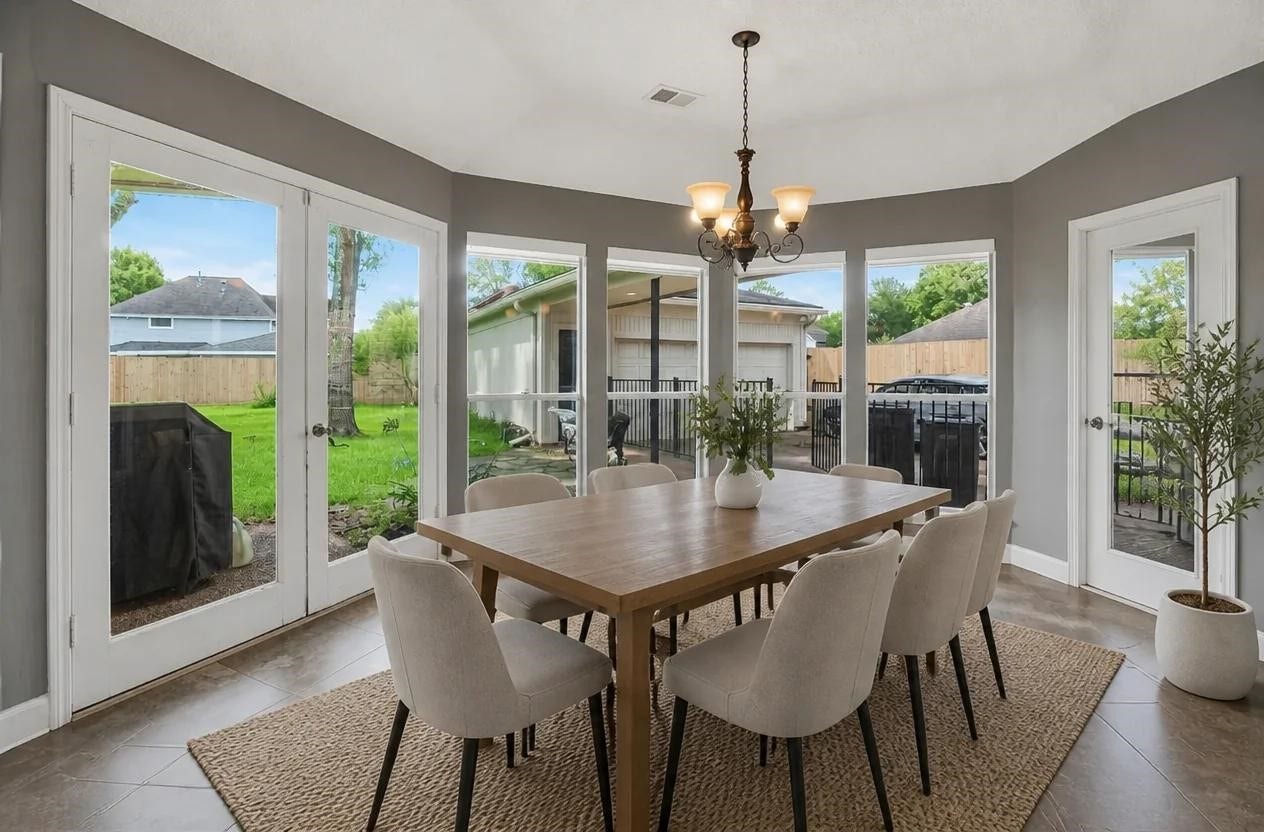 1523 Plantation Drive, Richmond, TX 77406 Casual Dining with tons of light and double doors to the covered back patio. Shown virtually staged.
