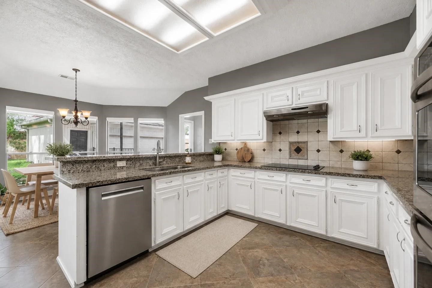 1523 Plantation Drive, Richmond, TX 77406 View of kitchen looking into casual dining and windows to the backyard.