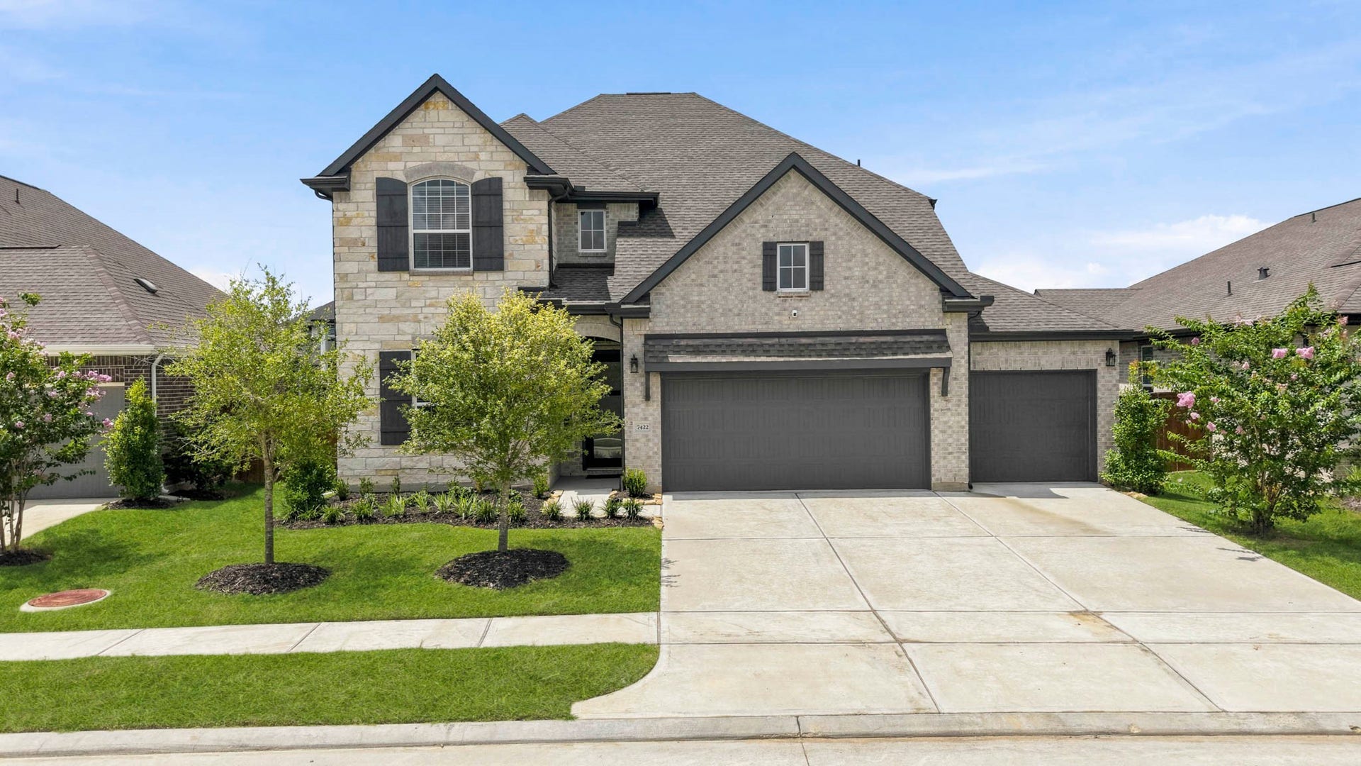 7422 Netherfield Lane, Katy, TX 77493 Welcome home to 7422 Netherfield Ln! This beautiful 2 story home welcomes you with a warm brick and stone exterior, contrasting shutters and accent paint, iron lanterns, and a spacious 3 car garage!
