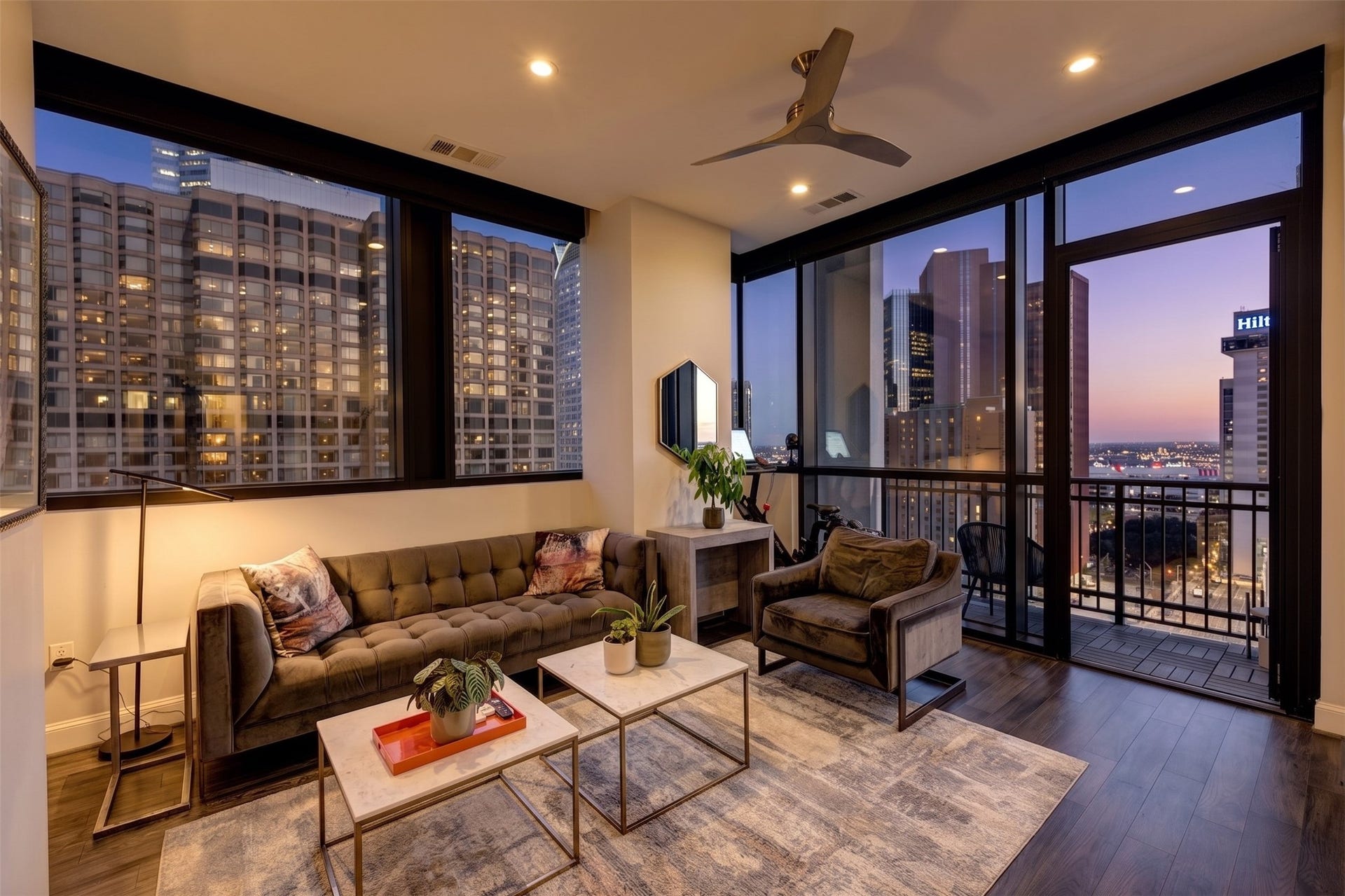 Light-filled living room with expansive windows and city views.