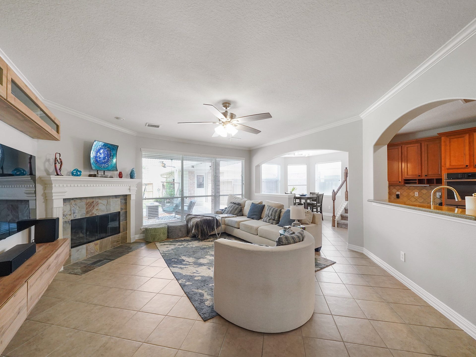 26214 Seminole Hill Lane, Katy, TX 77494 Anchored by a gas fireplace and framed by large windows, the family room offers a welcoming place to gather, relax, and connect.