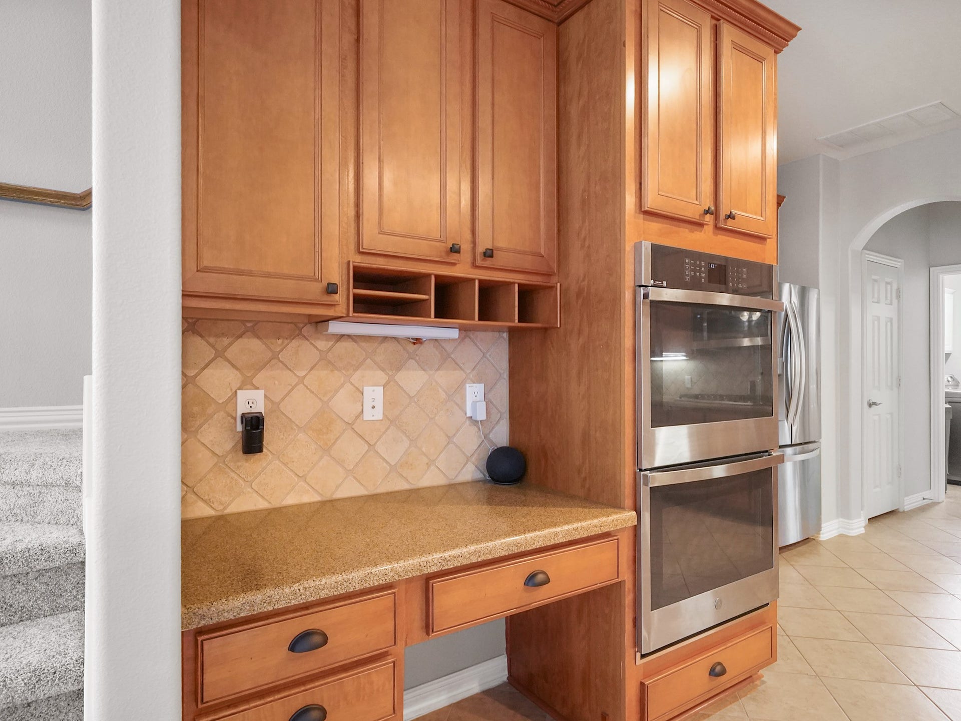 26214 Seminole Hill Lane, Katy, TX 77494 Tucked beside the secondary staircase, this built-in workstation creates the perfect command center for household organization, homework, or remote work.