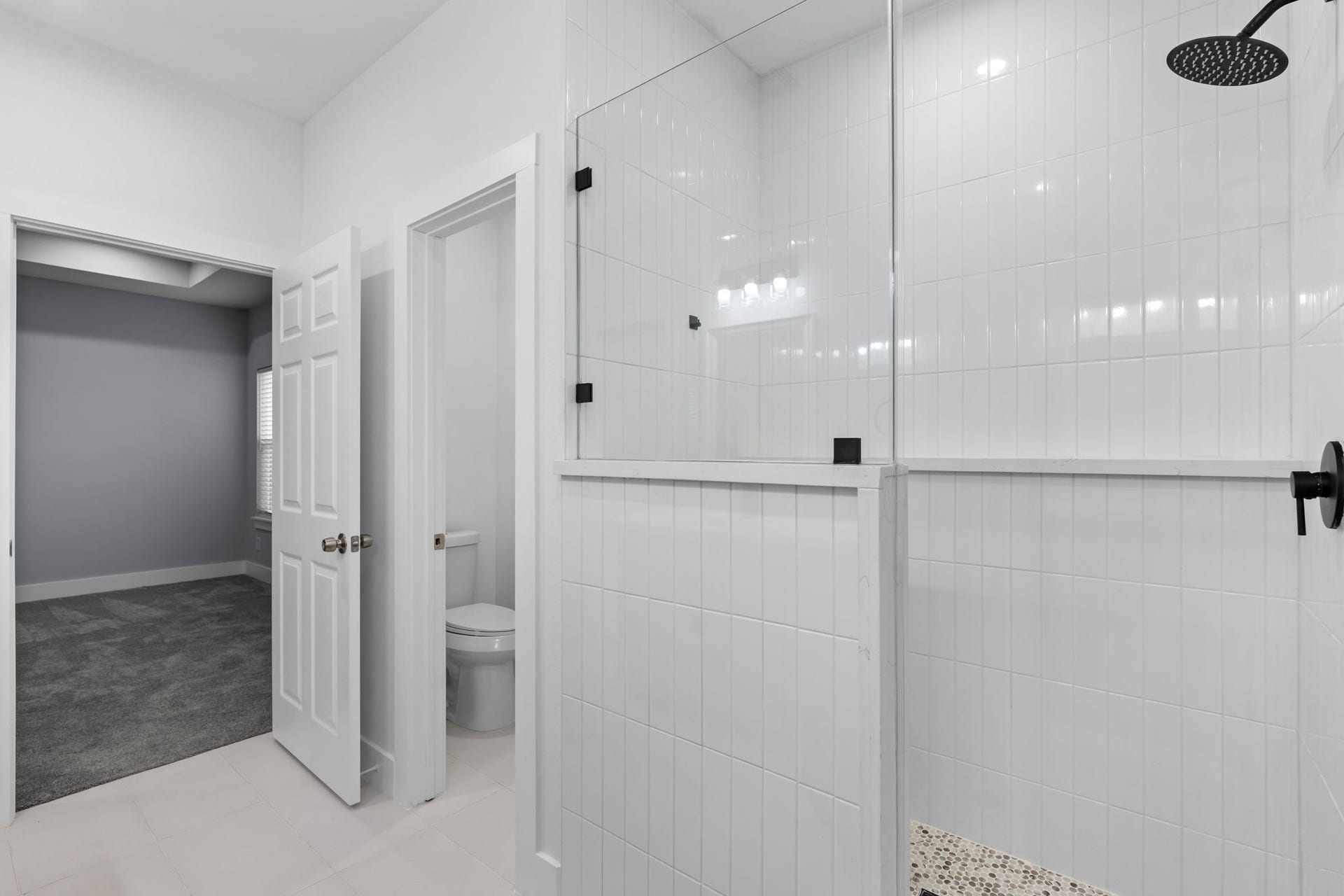 1303 Hawthorne Street, Baytown, TX 77520 Walk-in shower with a rain showerhead and glass enclosure
