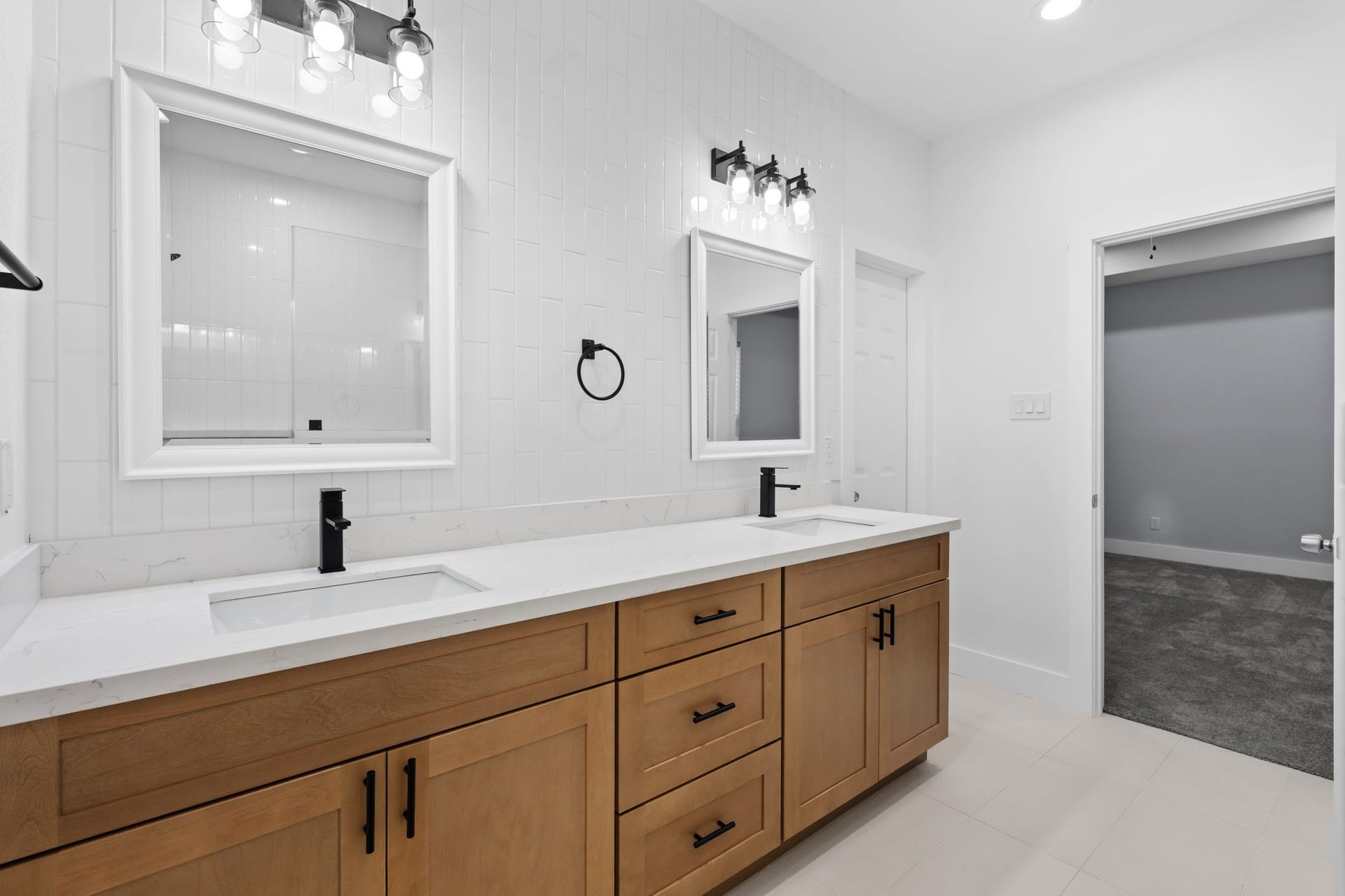 1303 Hawthorne Street, Baytown, TX 77520 Double vanity with quartz countertops and modern black fixtures