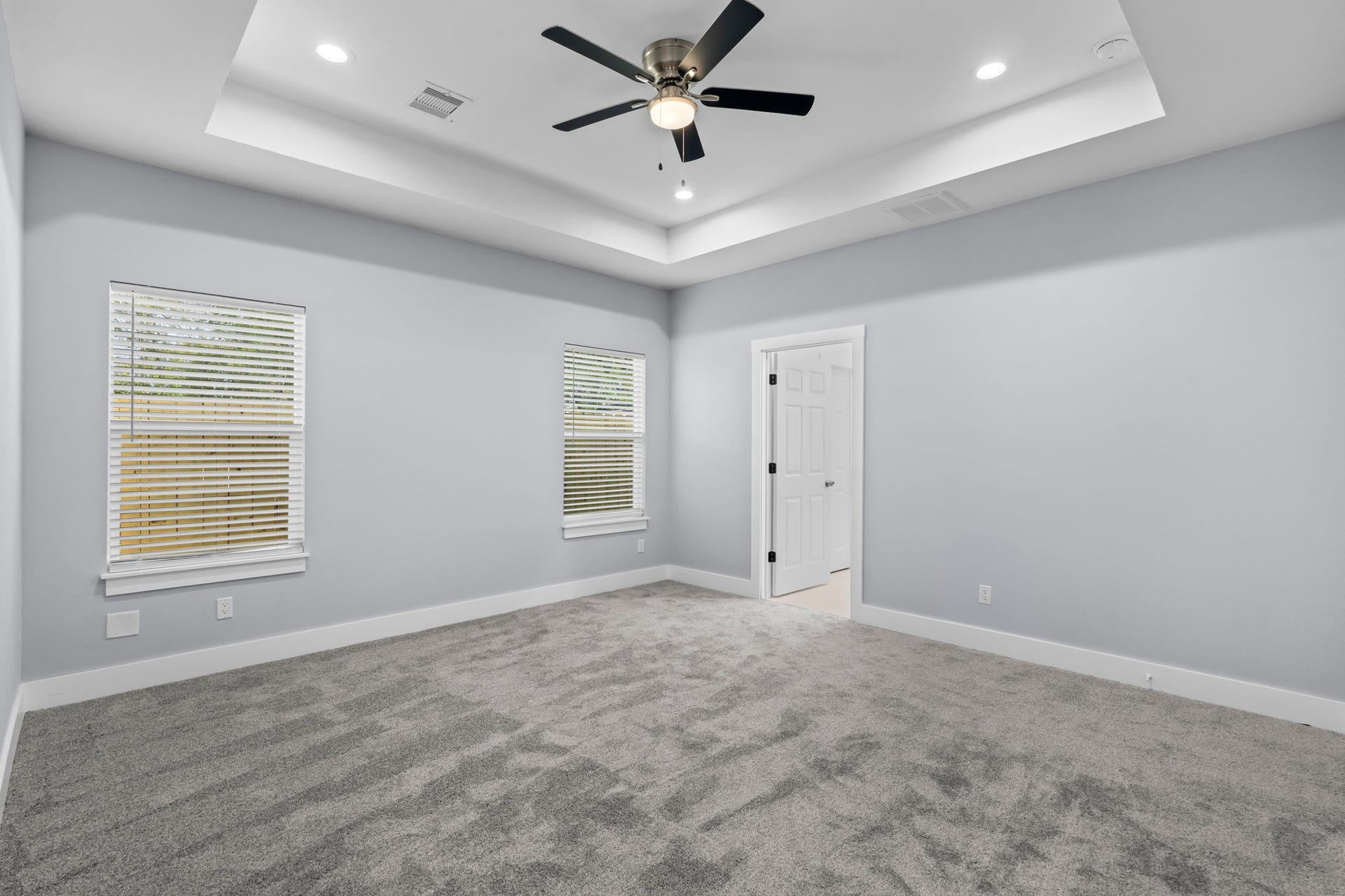 1303 Hawthorne Street, Baytown, TX 77520 Primary bedroom with a tray ceiling and ceiling fan