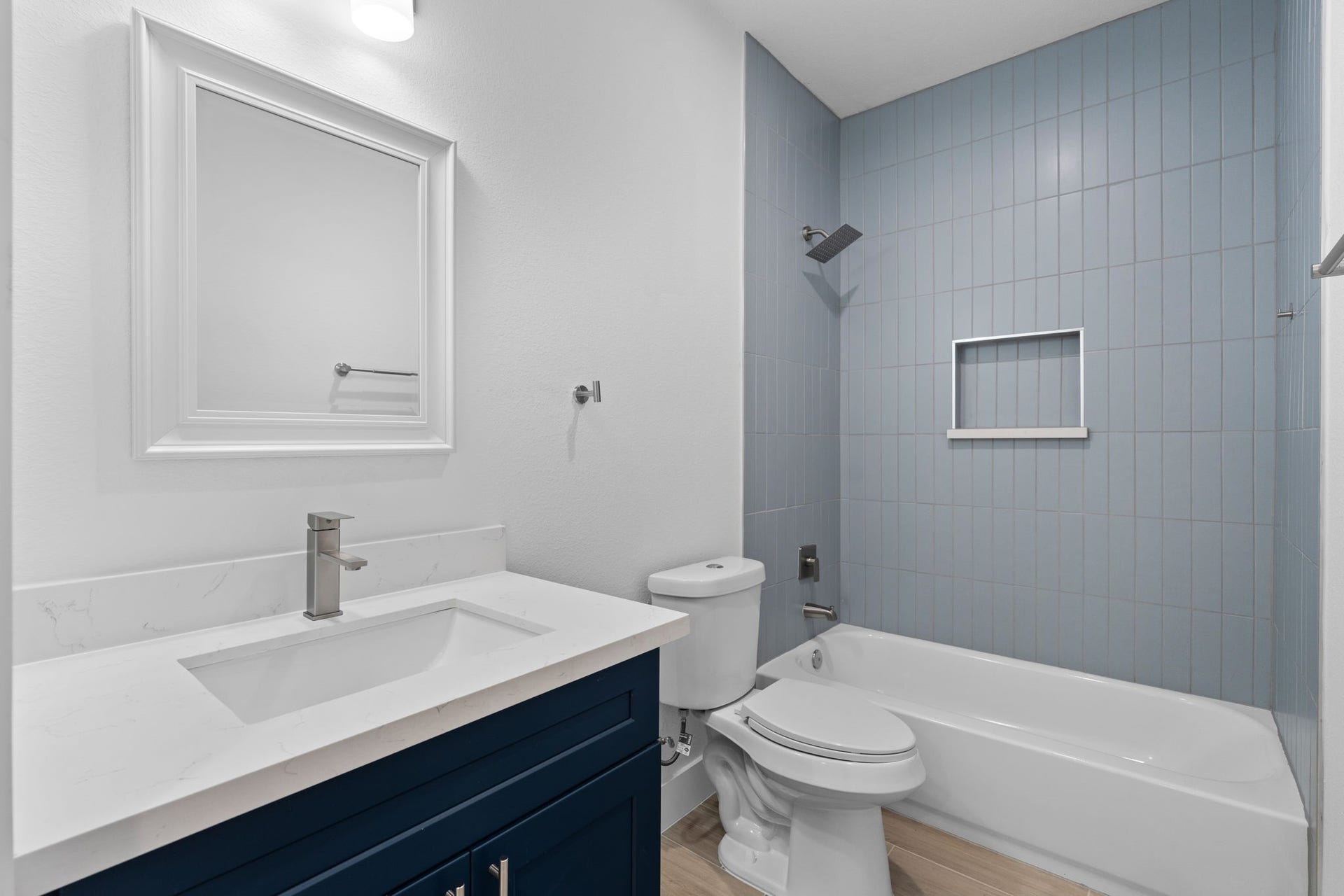 1303 Hawthorne Street, Baytown, TX 77520 Hall bath with floor-to-ceiling tile and a tub/shower combo