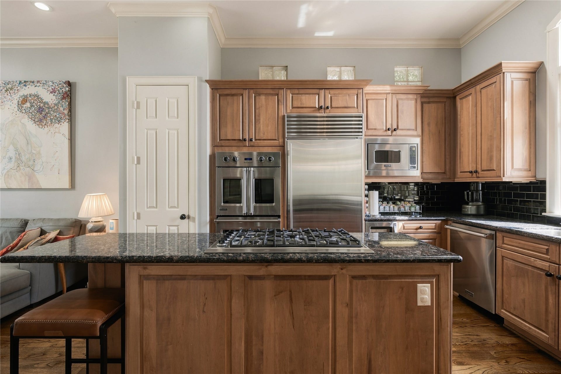523 Lovett Boulevard, Houston, TX 77006 At the center, an oversized island creates a true working kitchen, pairing generous prep space with a gas cooktop and seating for casual meals.