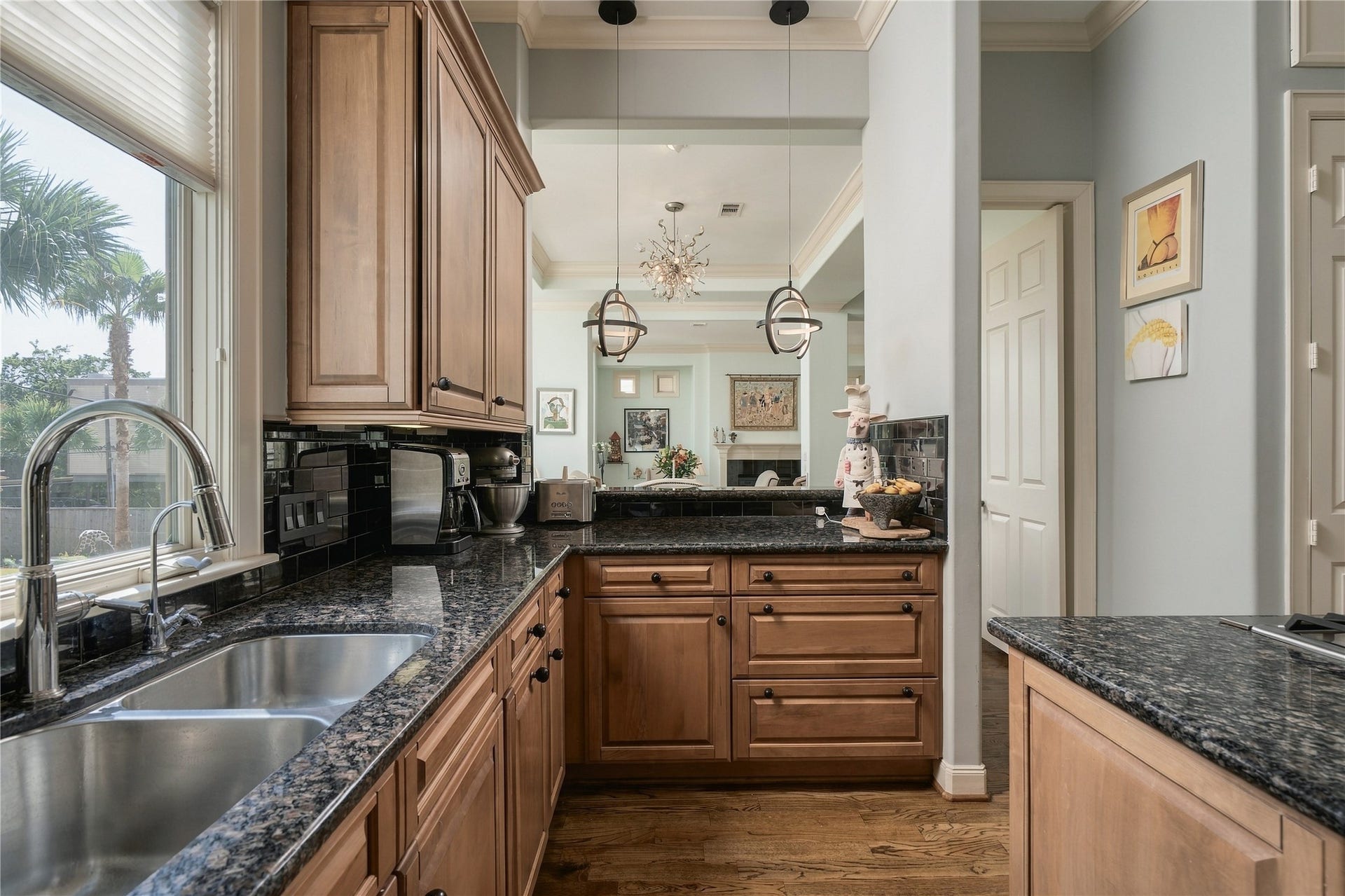 523 Lovett Boulevard, Houston, TX 77006 A pass-through keeps the kitchen visually connected to the dining and living rooms beyond, allowing light and conversation to move between each space.