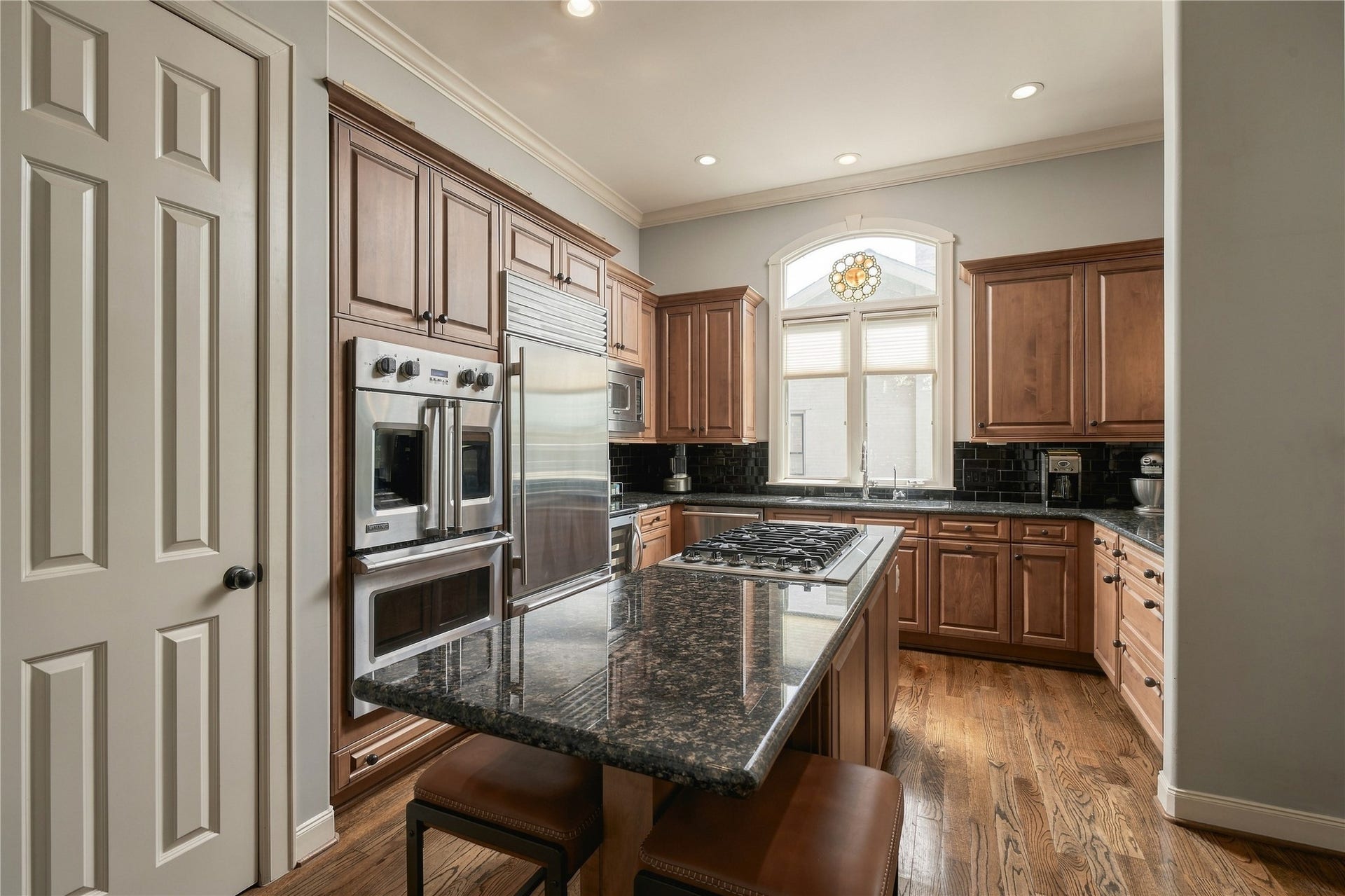 523 Lovett Boulevard, Houston, TX 77006 Theres room here for the way a kitchen actually gets used; cooking at the island, someone pulling up a stool, and conversation carrying in from the adjoining living spaces.