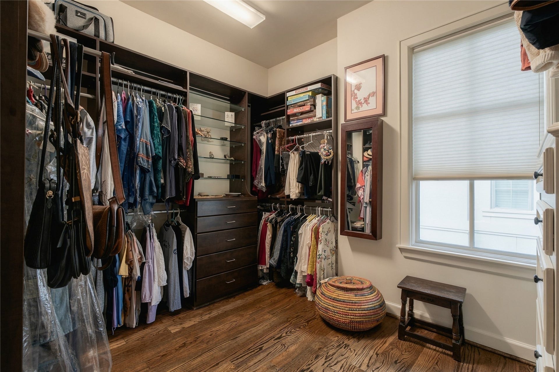 523 Lovett Boulevard, Houston, TX 77006 A spacious primary walk-in closet offers custom built-in organization with plenty of room for wardrobe storage.