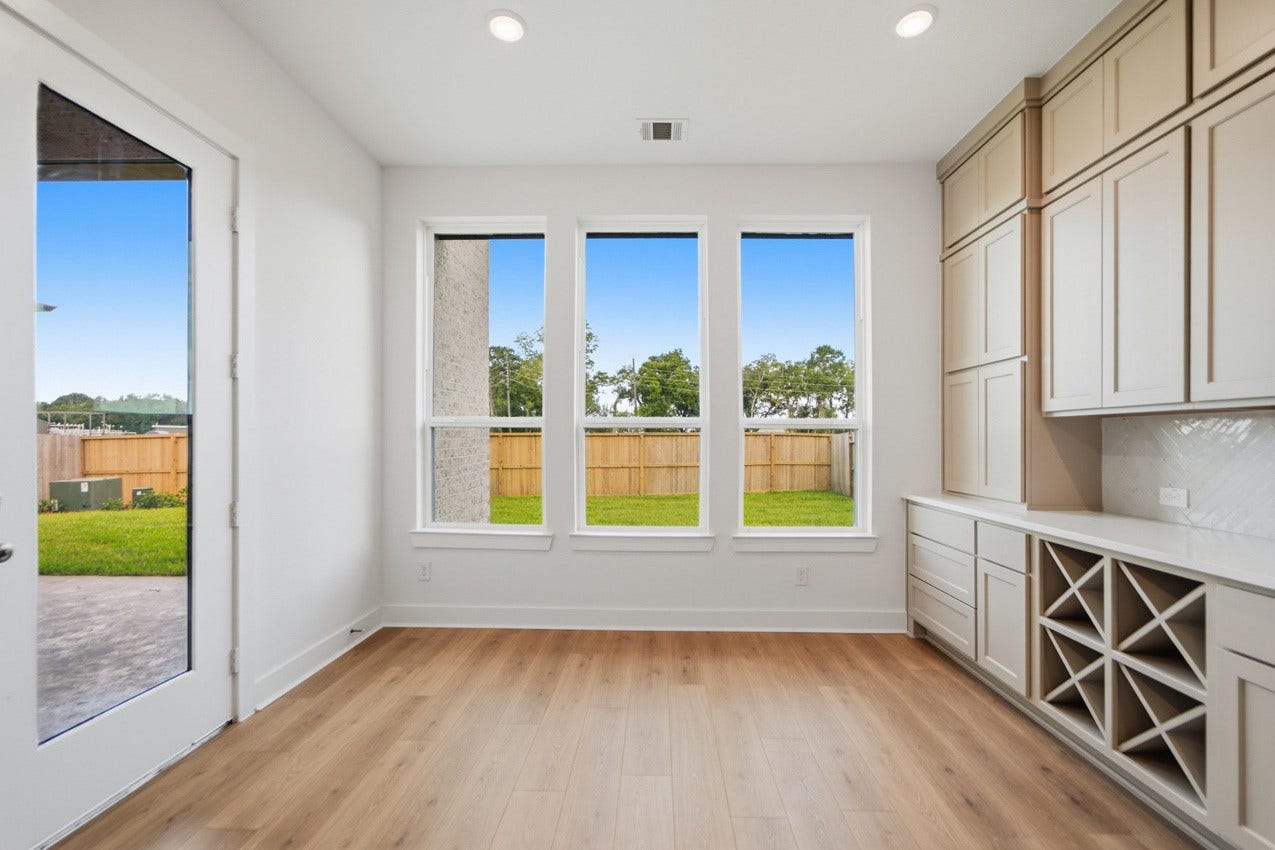 Sunny breakfast nook with backyard views and seamless access to the kitchen and family room.