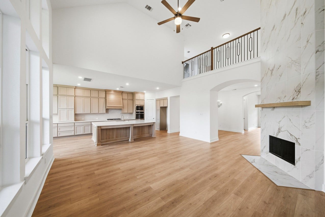 Spacious family room seamlessly connected to the kitchen, creating an ideal gathering space.