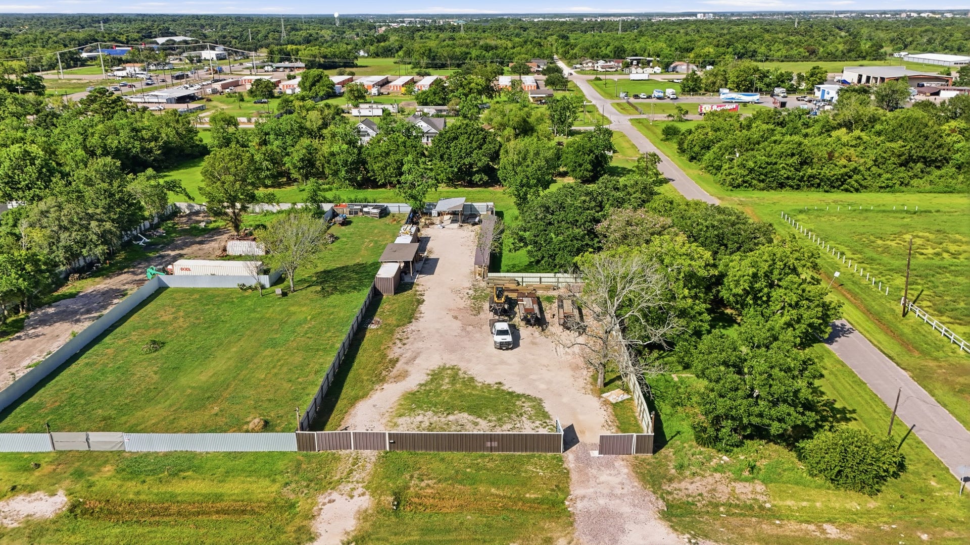 1406 Hill Avenue, League City, TX 77573 Front aerial view showcasing the fully fenced 19,500 SF light industrial property.