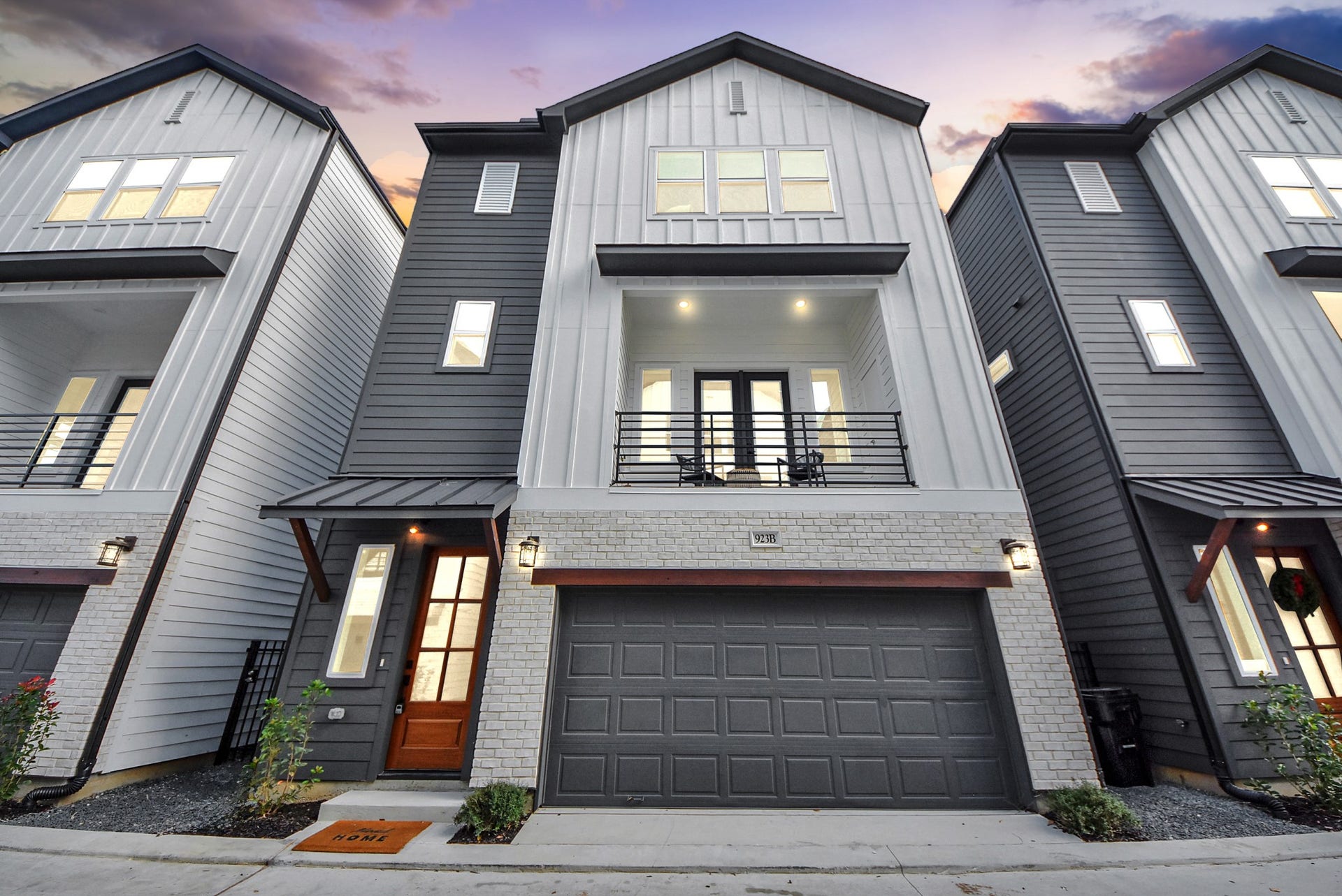 927 Fisher Street, #B, Houston, TX 77018 These modern three-story townhomes showcase clean lines and mixed materials, each with a two-car garage and balcony. The design blends style and functionality, ideal for urban living.