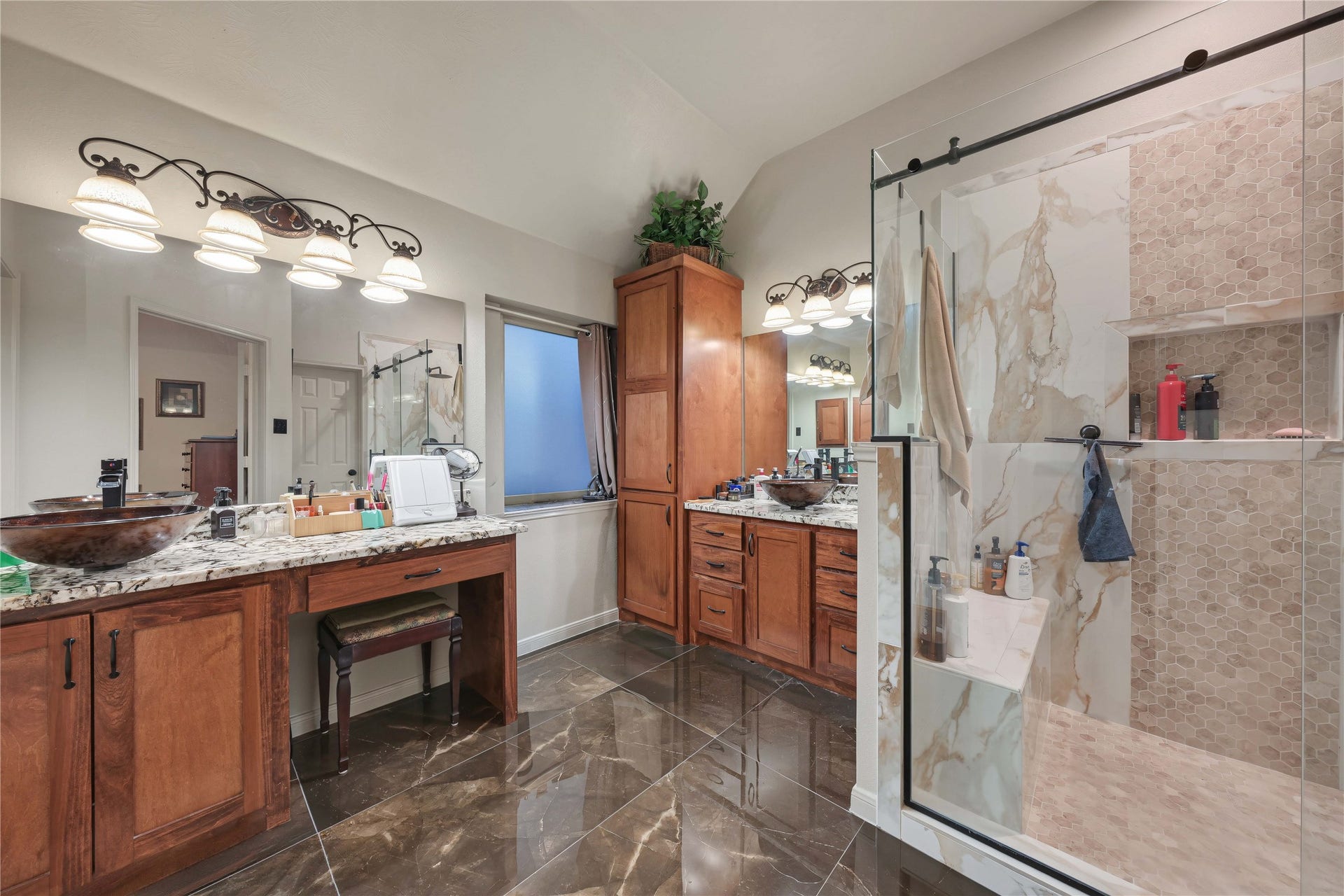 1918 Oakwood Court Drive, Baytown, TX 77521 Primary bathroom with oversized shower with bench, custom cabinets, and glamorous oversized tile floors
