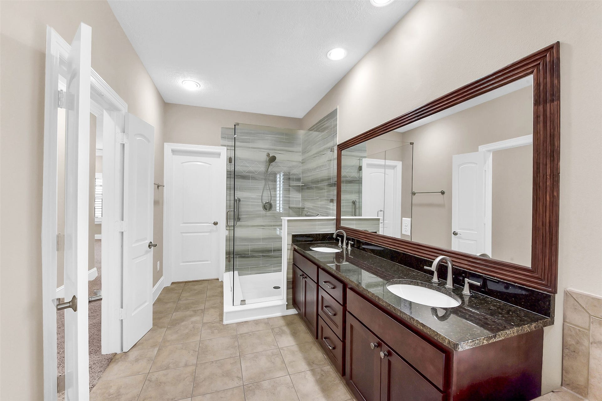 905 Garden Oaks Trace, Houston, TX 77018 Enjoy the West Shore Custom glass enclosed shower in this large primary bathroom with soaking rub.