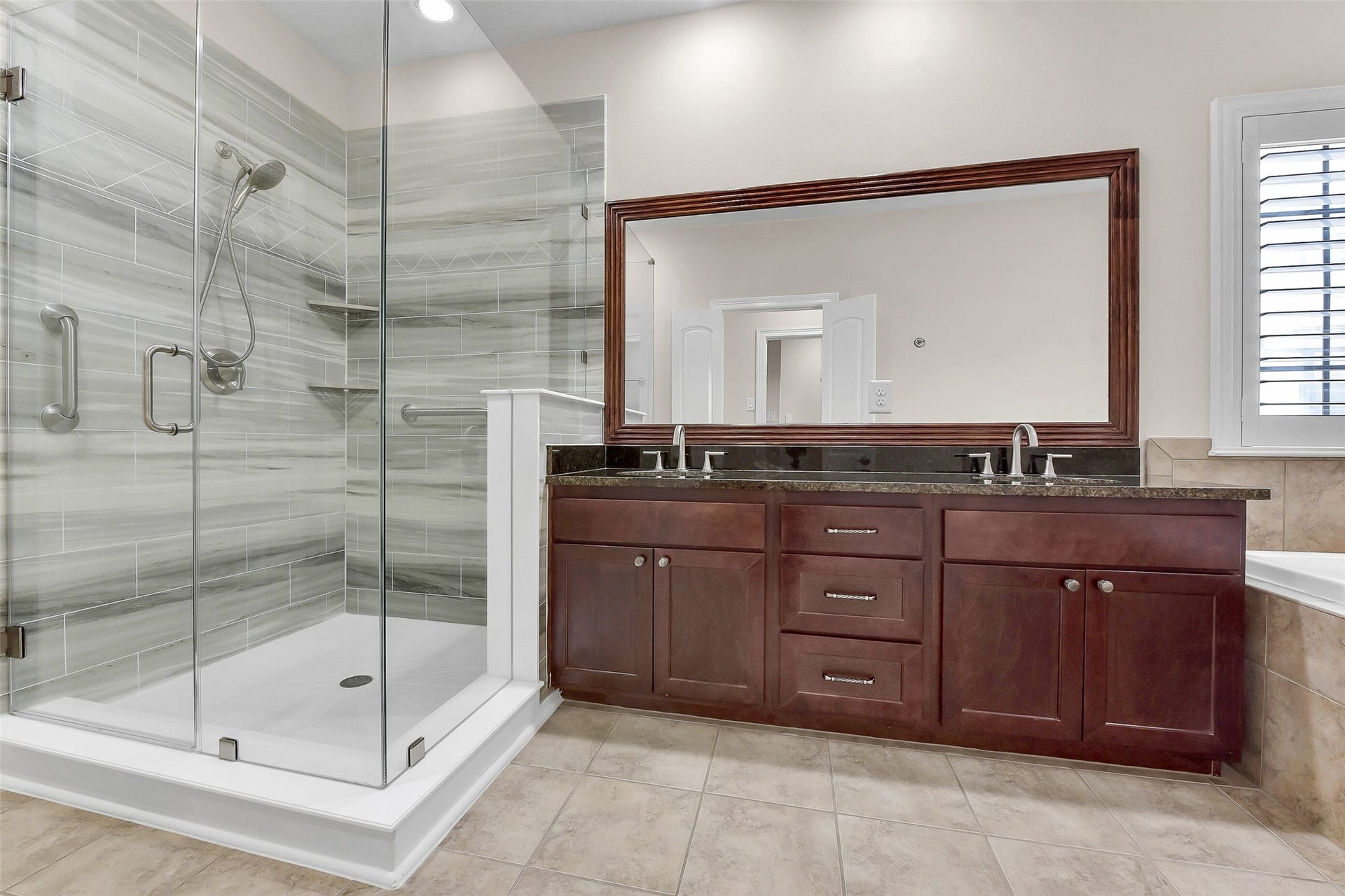 905 Garden Oaks Trace, Houston, TX 77018 In addition to the oversized shower, the large vanity houses two sinks, plus canbinets and drawers for storage.