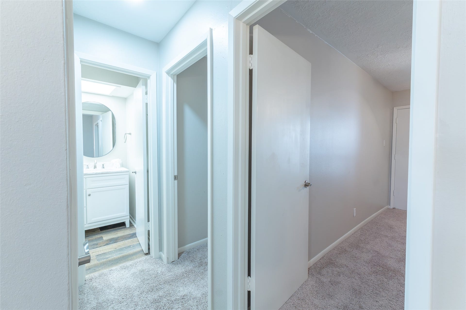 secondary bathroom on the left, second and third bedrooms on the right