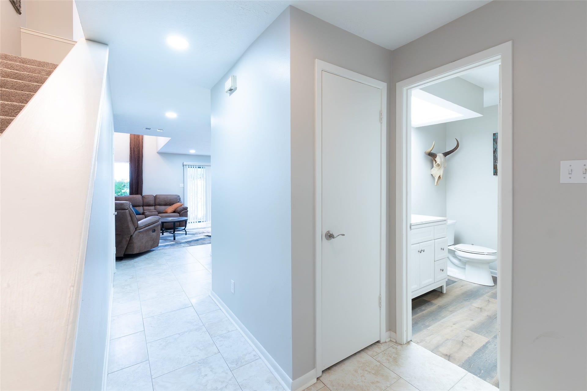 hallway to front of house, stairs on the left, closet. half bath