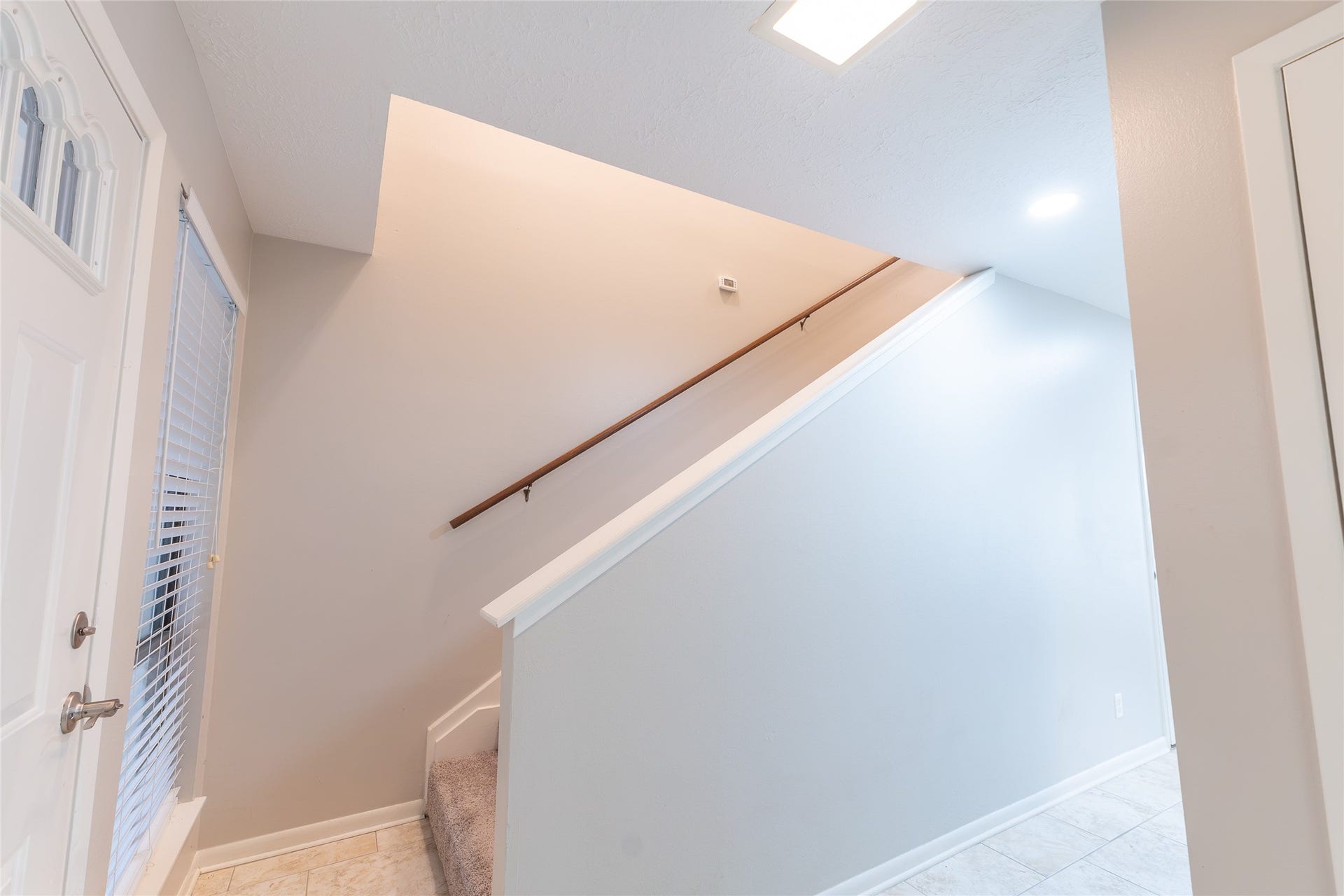 left side: door to garage, door to flex room / play room, stairs on the right