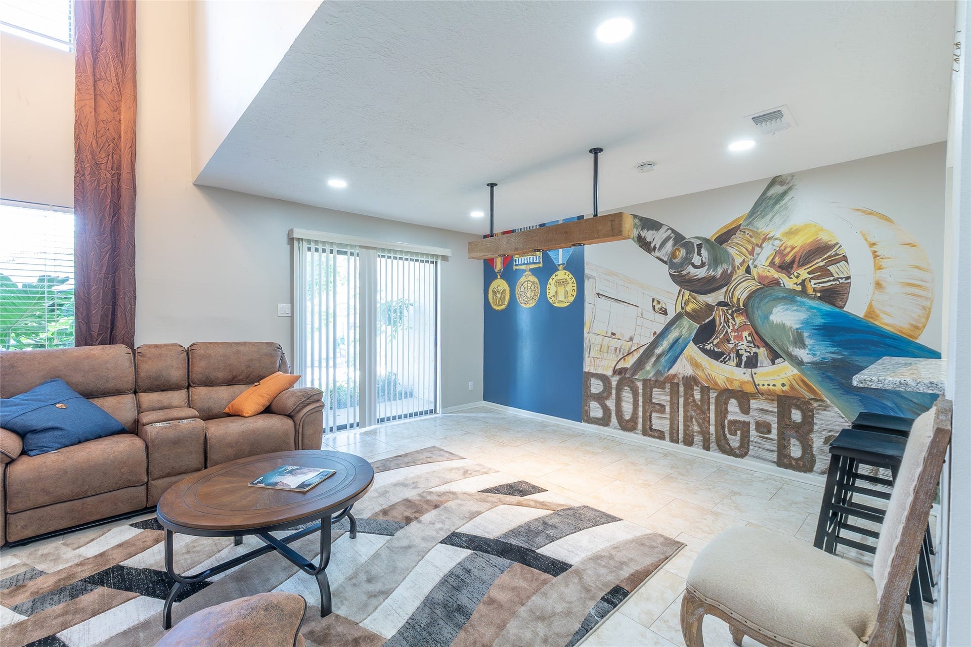 family room, front door in the middle, mural on the right