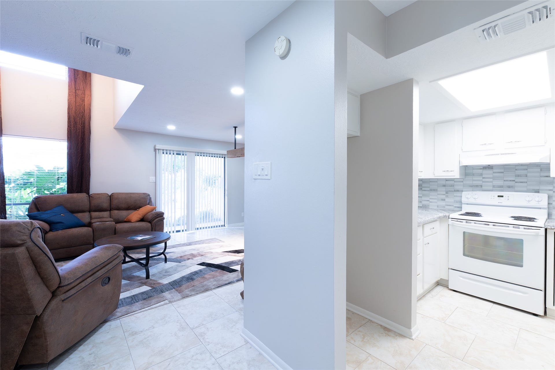 living on left, front door, refrigerator space right center, kitchen