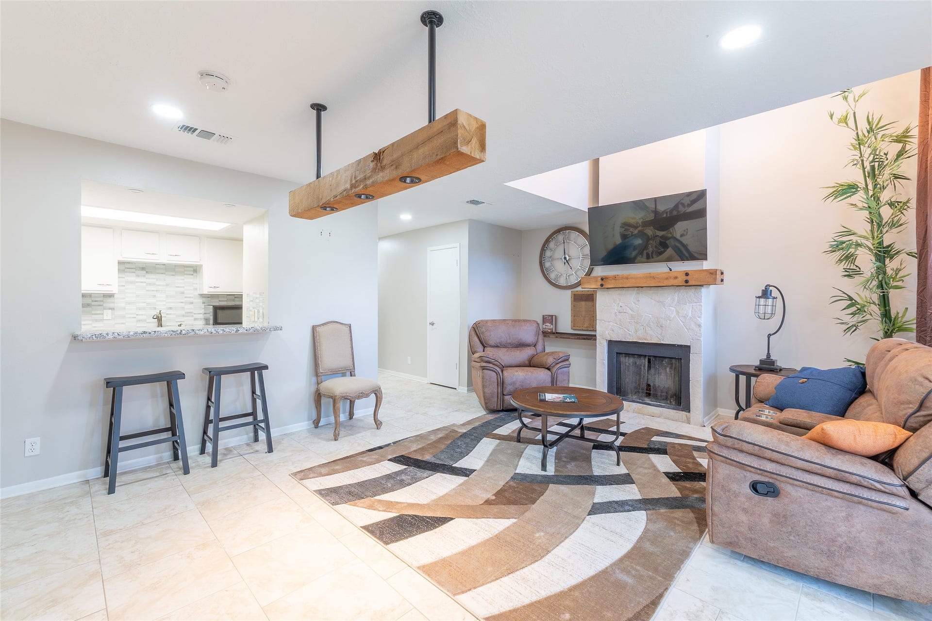 from front: door kitchen on the left, living room on the right, light fixture (wooded top middle) would lighten dining table and chairs.