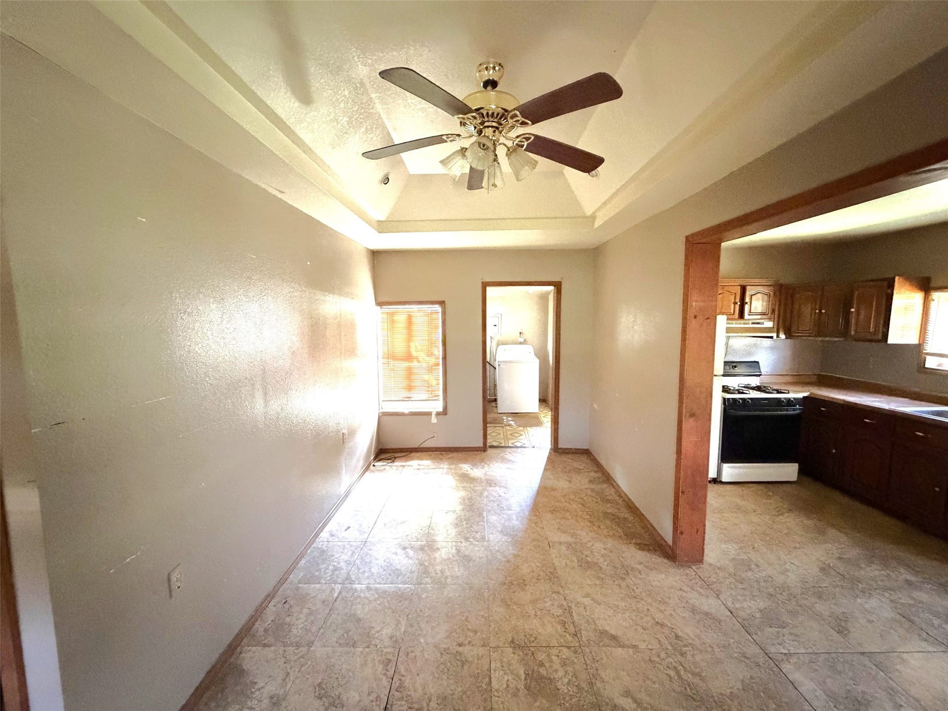 209 S Avenue C, Freeport, TX 77541 Stepping inside the first house, you enter the living area with the utility room and bathroom straight ahead and the kitchen on your right.