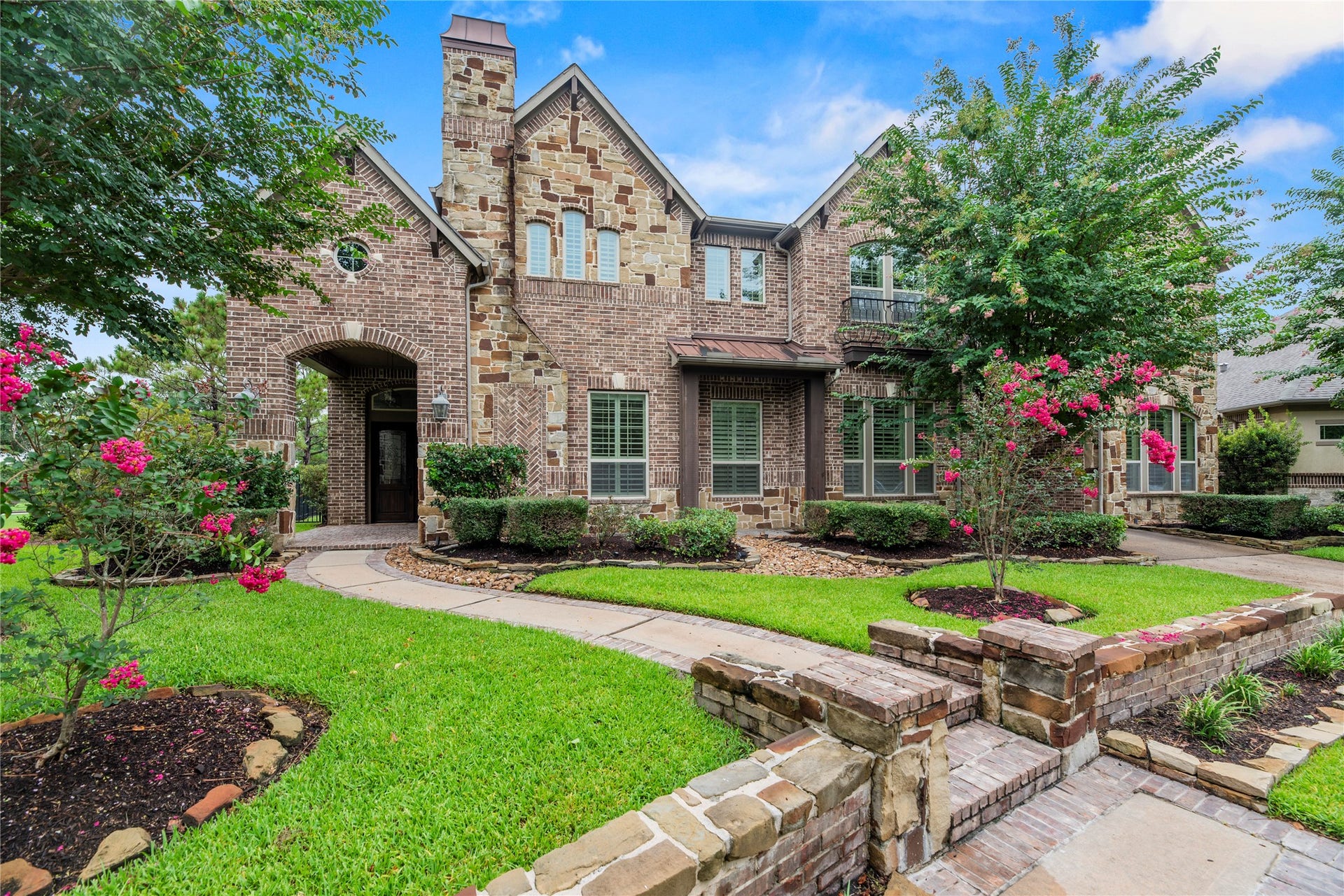 19003 Cove Manor Drive, Cypress, TX 77433 Elegant brick and stone exterior with beautifully landscaped curb appeal.
