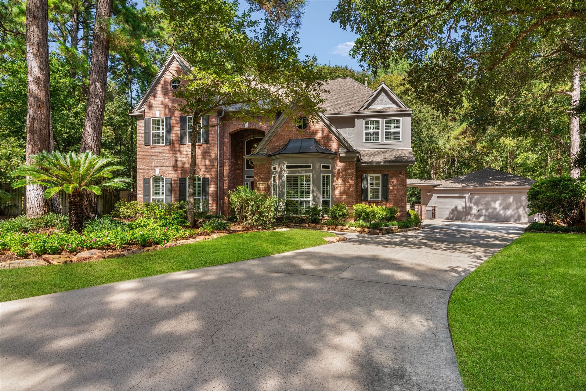 66 Coldbrook Court, The Woodlands, TX 77381 Gorgeous traditional brick elevation enhanced by a charming bay widow and beautiful landscaping, all creating exceptional curb appeal.