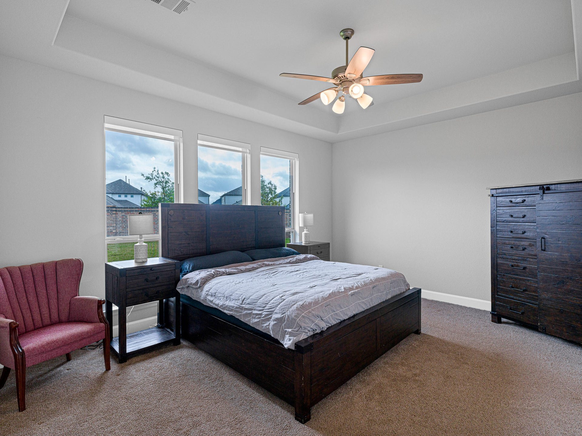608 Malibu Pines Drive, Katy, TX 77493 Primary bedroom suite with tray ceiling, fan and light filtering roller shades.