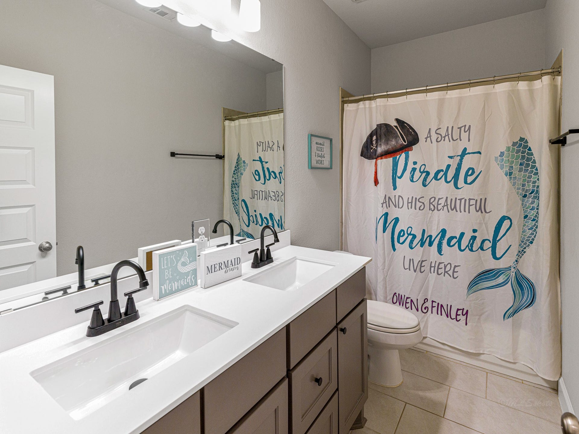 608 Malibu Pines Drive, Katy, TX 77493 Bathroom has room for two or more with double sinks. Matte black sink faucets were recently added.