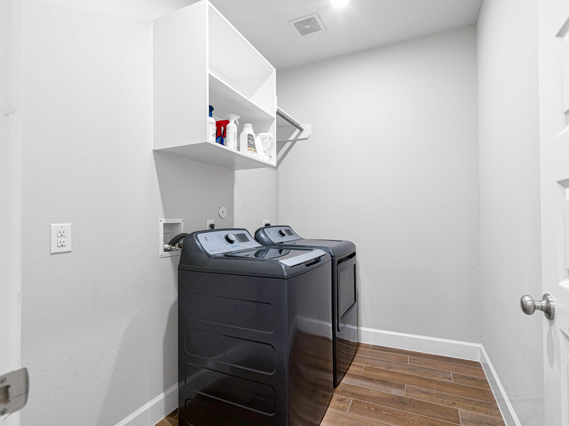 608 Malibu Pines Drive, Katy, TX 77493 Spacious laundry room with shelves and hanging rod, and tile flooring.