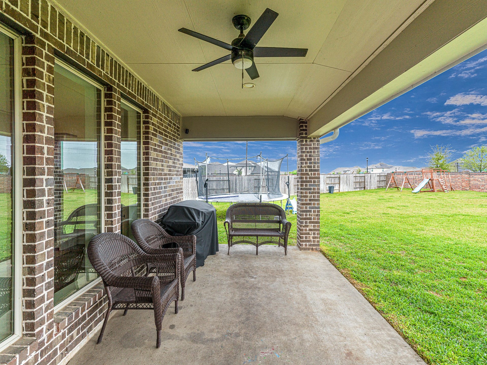 608 Malibu Pines Drive, Katy, TX 77493 Covered patio with ceiling fan overlooks expansive, private backyard with no neighbors behind!