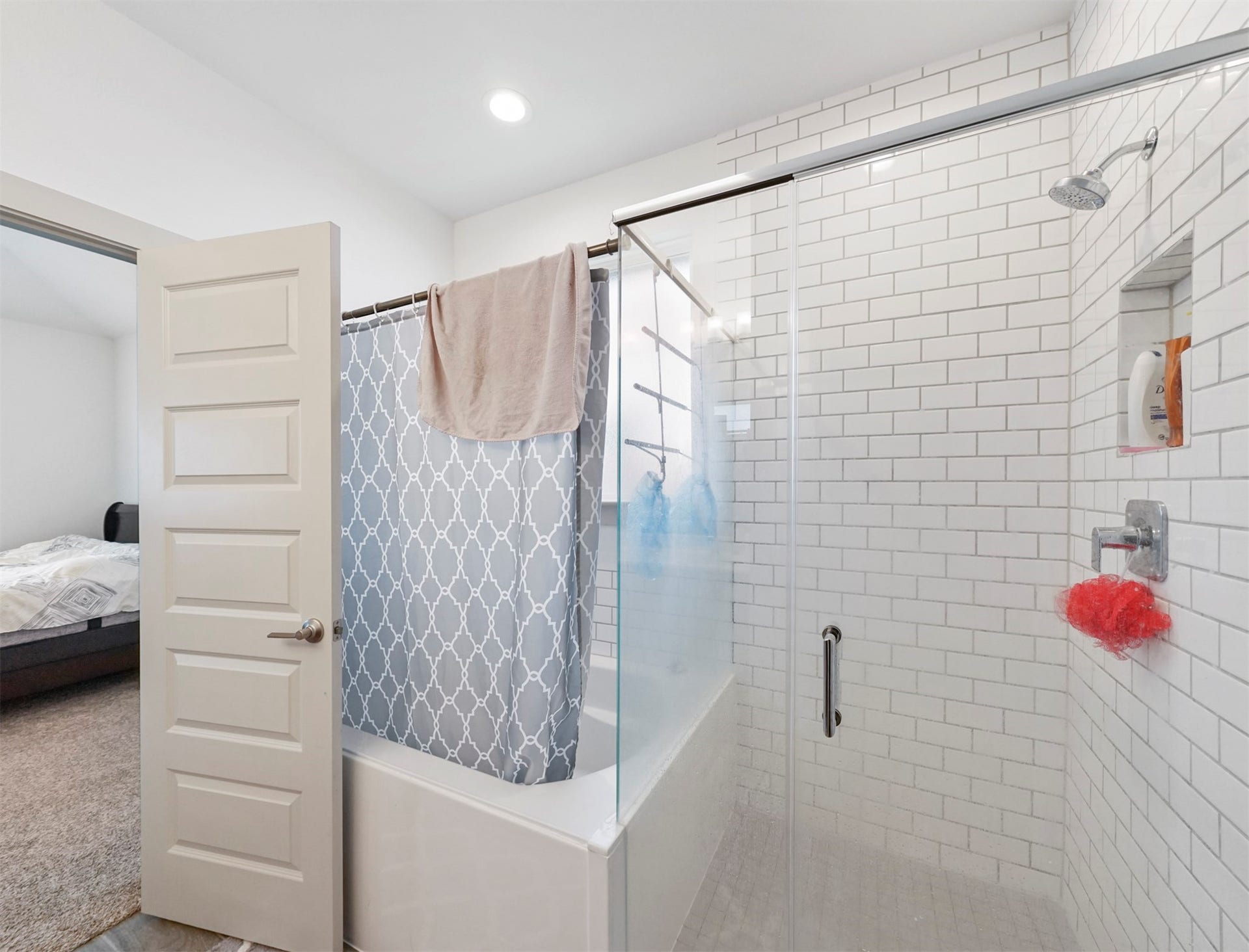 28226 Hazel Trail, Katy, TX 77494 A separate walk-in shower with white subway tile, a glass enclosure, and a built-in niche sits beside a soaking tub.