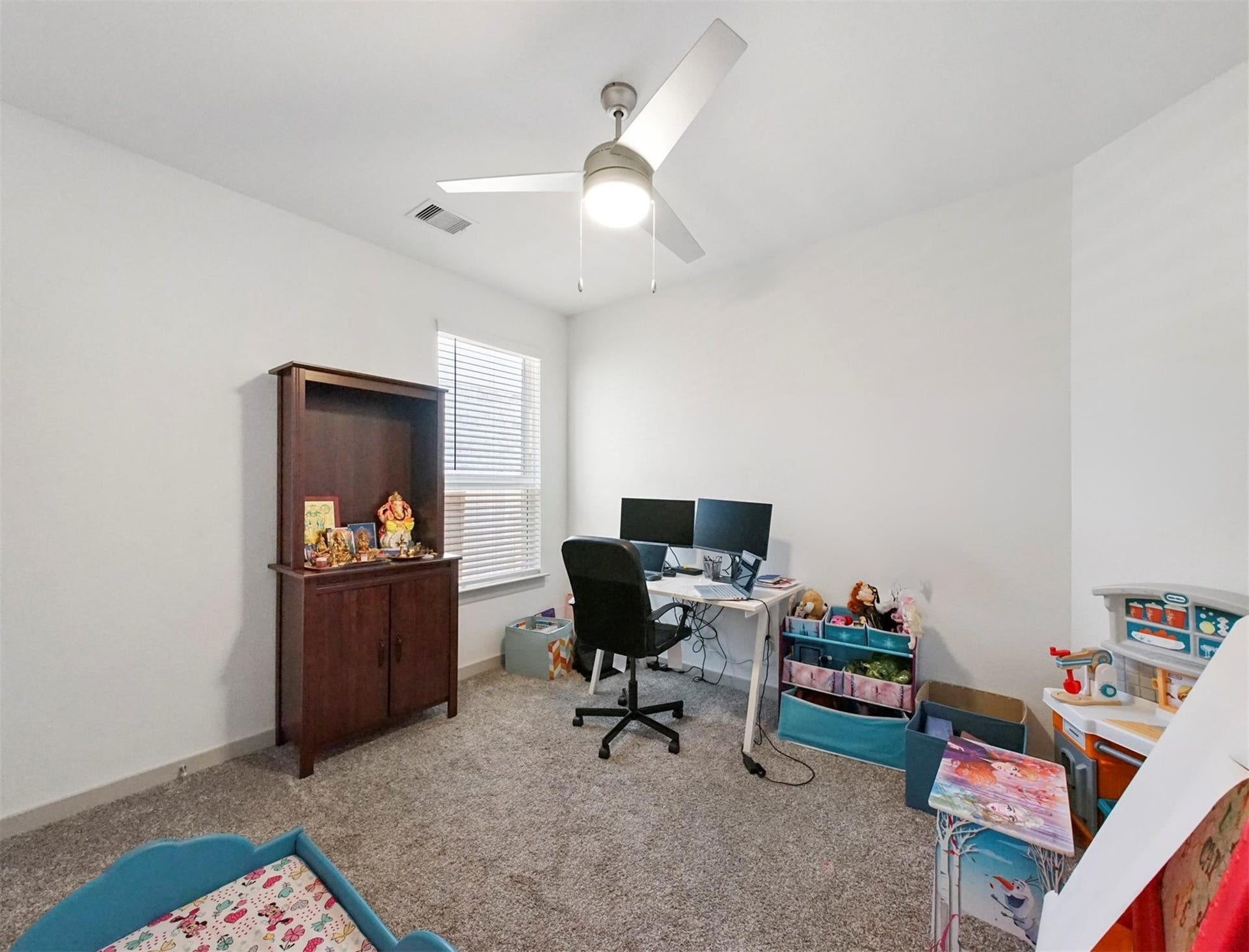 28226 Hazel Trail, Katy, TX 77494 This flexible secondary bedroom adapts easily as a guest room or a dedicated home office, complete with a ceiling fan and a window with blinds.