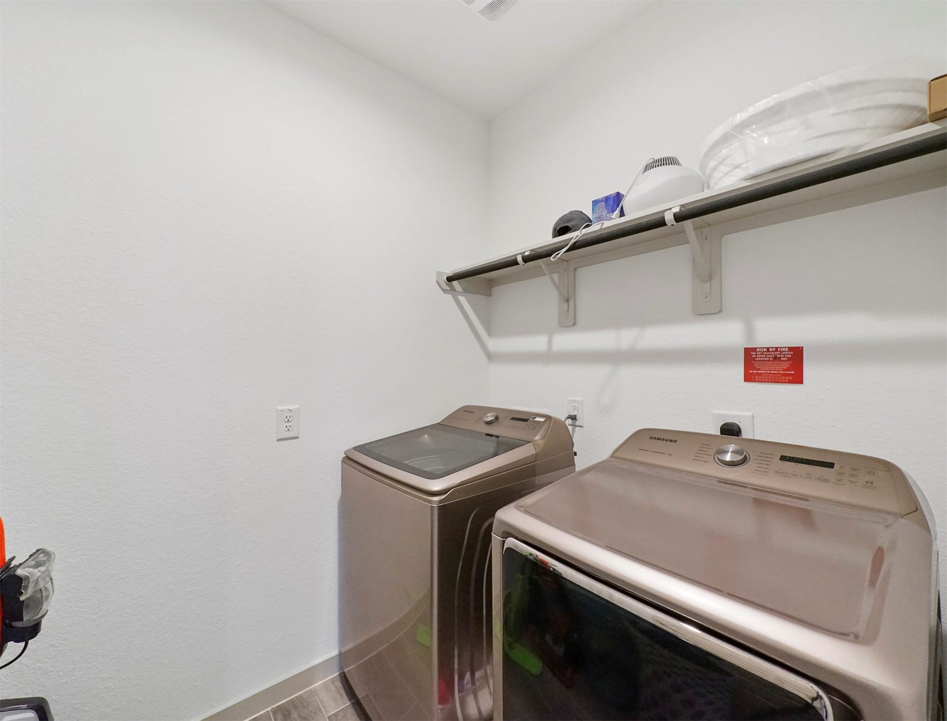28226 Hazel Trail, Katy, TX 77494 The dedicated laundry room keeps chores organized, with washer and dryer connections and a built-in shelf with a hanging rod for folding and drying.