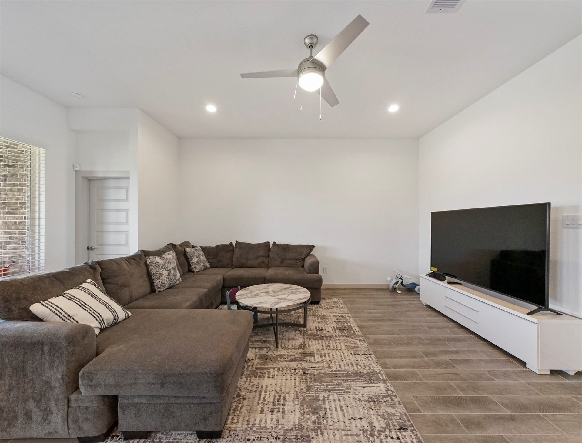 28226 Hazel Trail, Katy, TX 77494 The living room has a ceiling fan with light and a large window, plus plenty of open wall space for flexible furniture placement.
