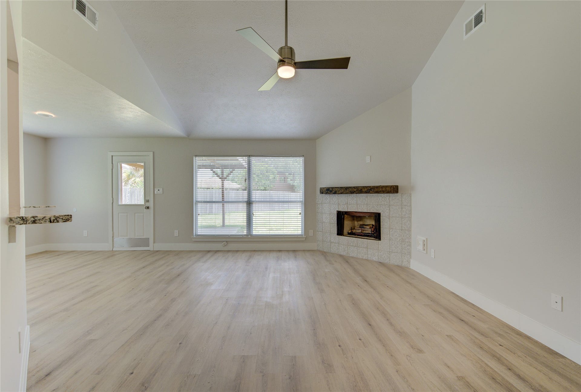 4931 Lake Catherine Court, Richmond, TX 77407 An open airy living space designed for comfortable everyday living, featuring dramatic ceiling height updated flooring and seamless flow to the kitchen and dining areas