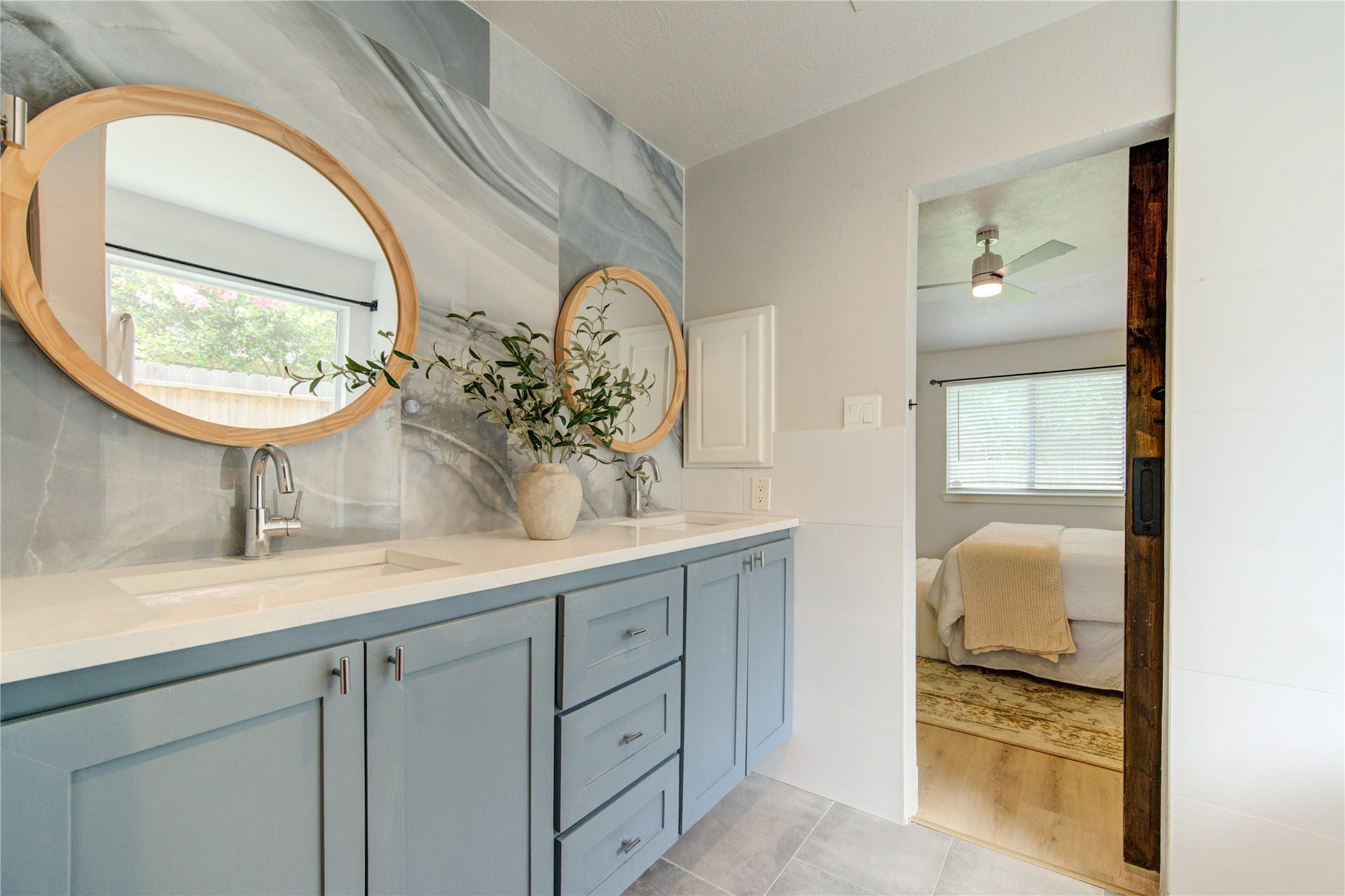 4931 Lake Catherine Court, Richmond, TX 77407 Enjoy a spa-inspired primary bath featuring dual sinks, abundant vanity storage, contemporary fixtures and direct access to the spacious primary suite through a custom barn door