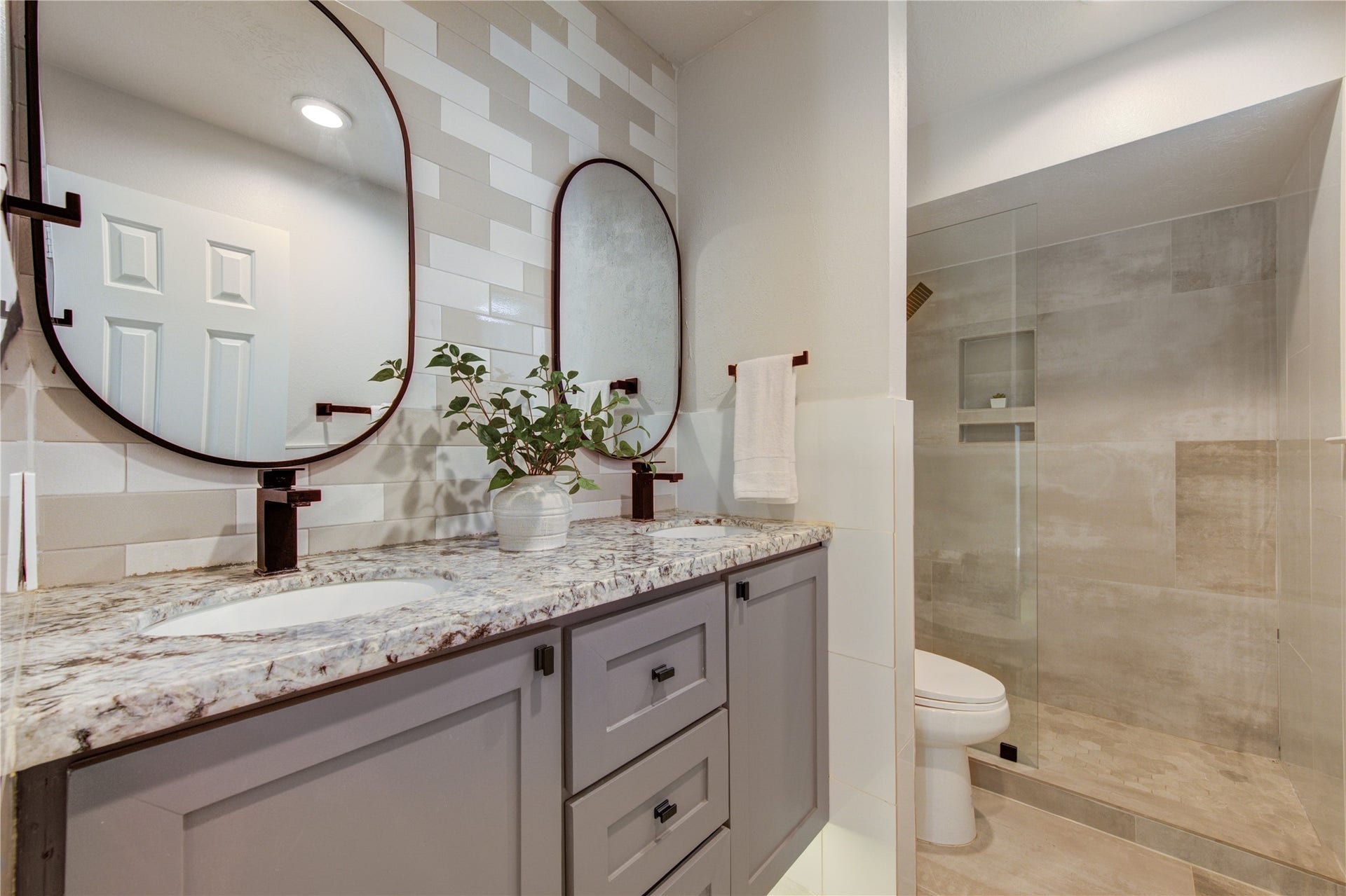 4931 Lake Catherine Court, Richmond, TX 77407 Bathroom 2- floating cabinet features under-cabinet LED lighting