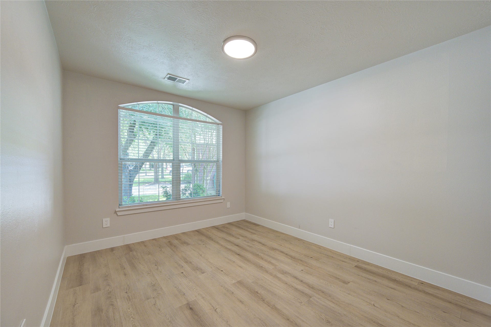 4931 Lake Catherine Court, Richmond, TX 77407 Relax in the spacious secondary bedroom featuring oversized windows, updated luxury vinyl plank flooring