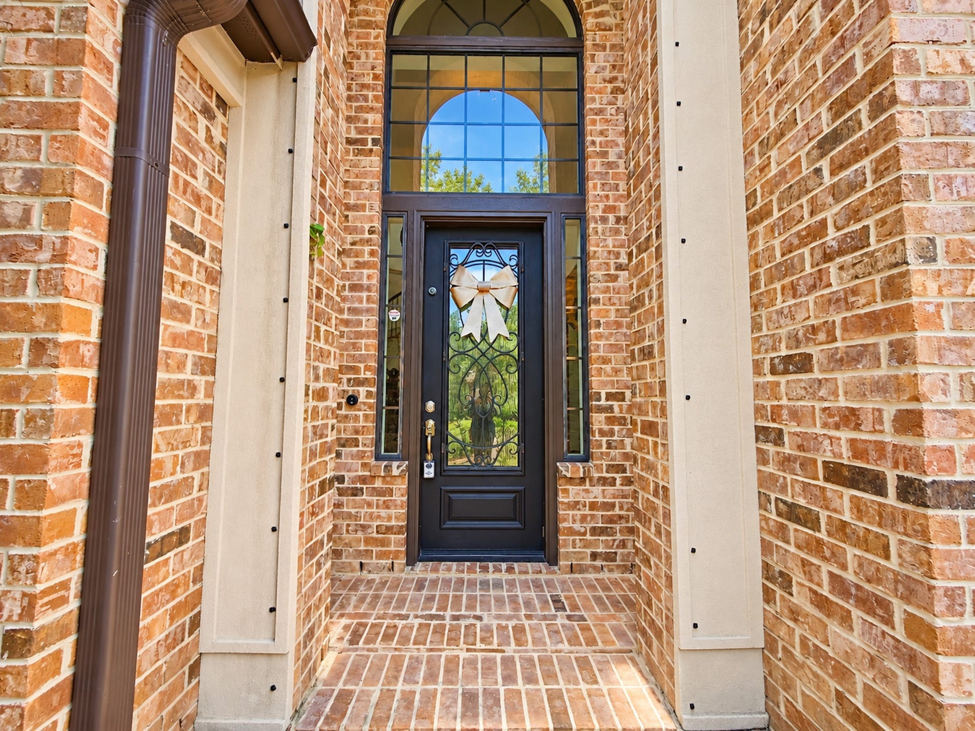 2514 Barcelona Way, League City, TX 77573 Arched iron-and-glass front door framed in brick.