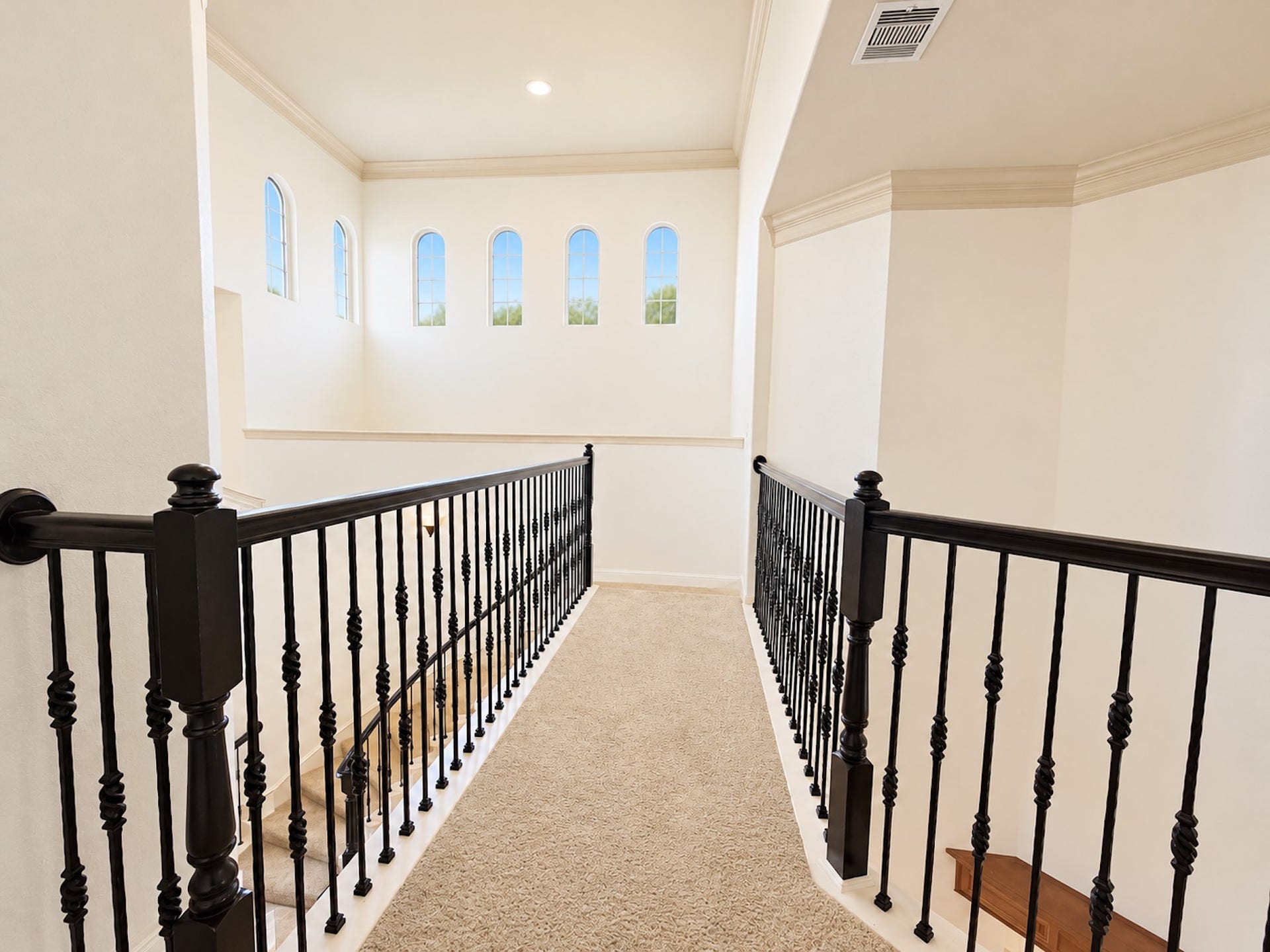 2514 Barcelona Way, League City, TX 77573 Upstairs walkway with iron railings and clerestory windows.