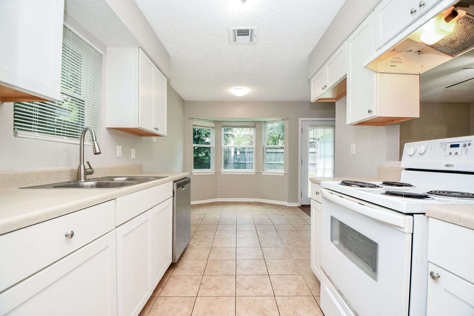 922 Bacliff Drive, Bacliff, TX 77518 This galley kitchen is plenty wide for two people to work in. The view to the back through the large windows makes this space feel even larger.