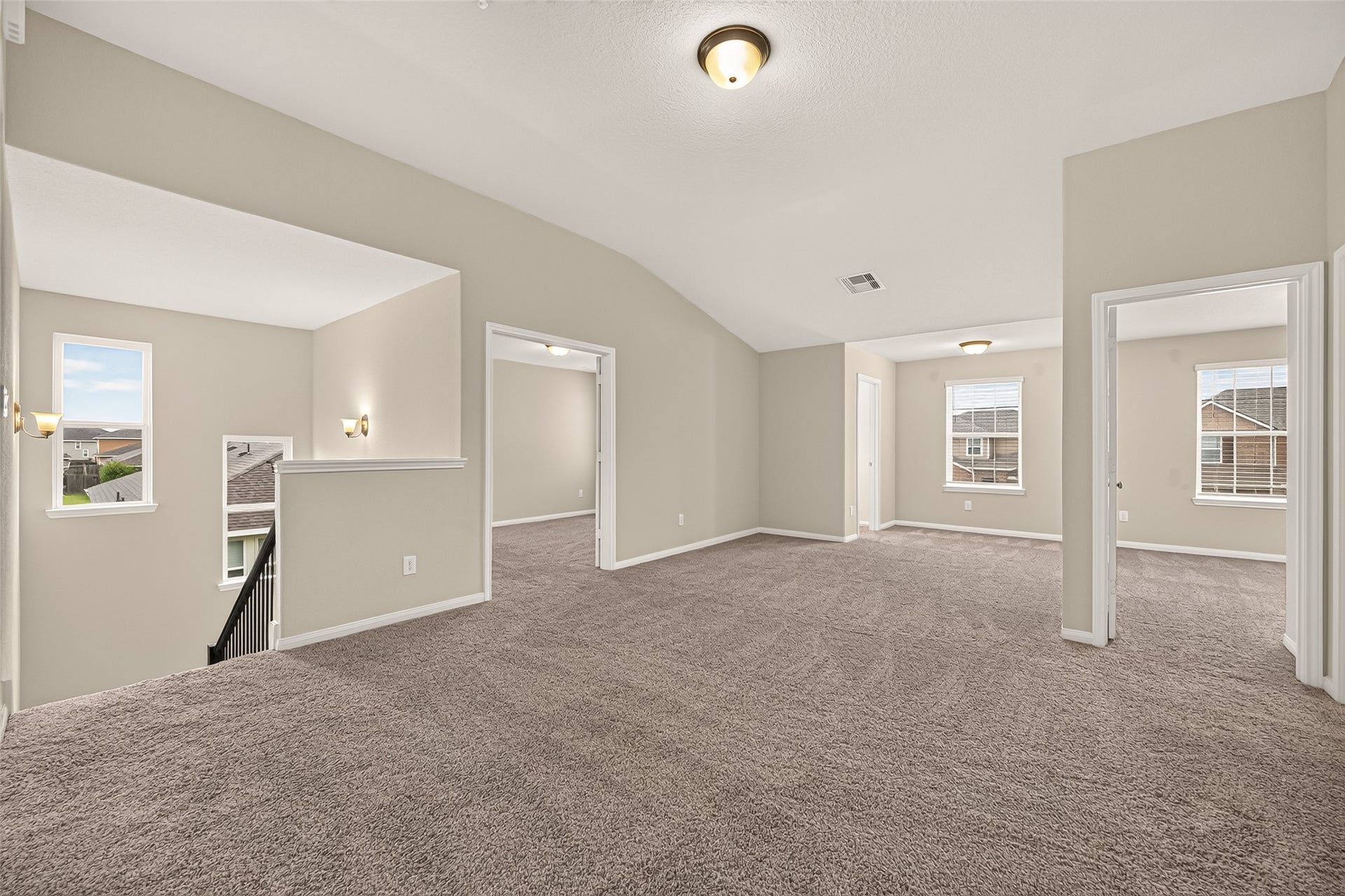 Spacious and inviting, the 2nd floor carpeted living area features neutral tones, ample natural light, and convenient access to adjoining rooms, perfect for versatile living arrangements.