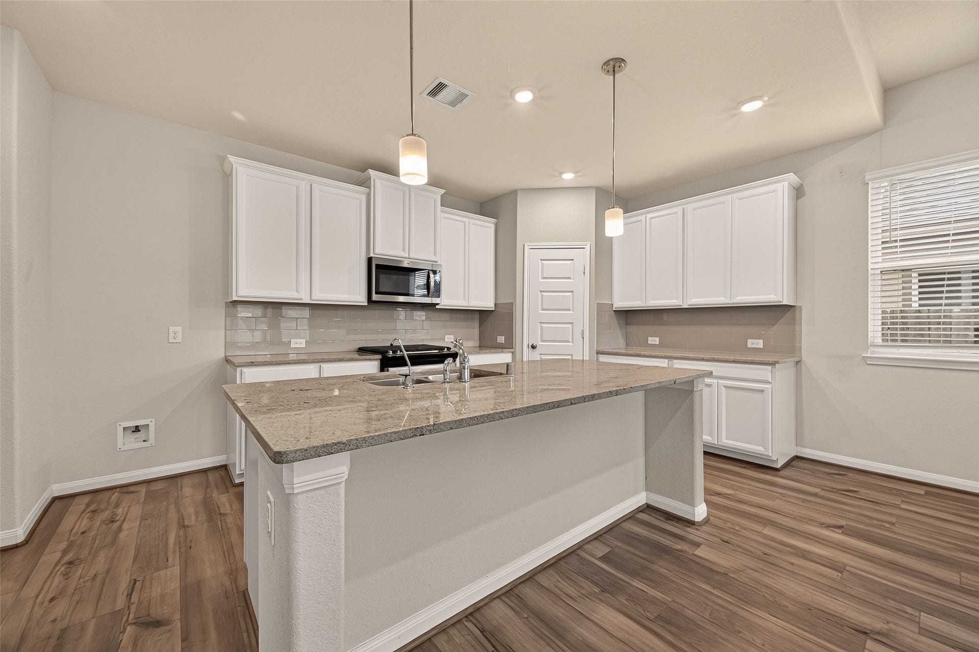 Experience the perfect blend of style and functionality in this kitchen, featuring ample cabinet space for all your essentials.