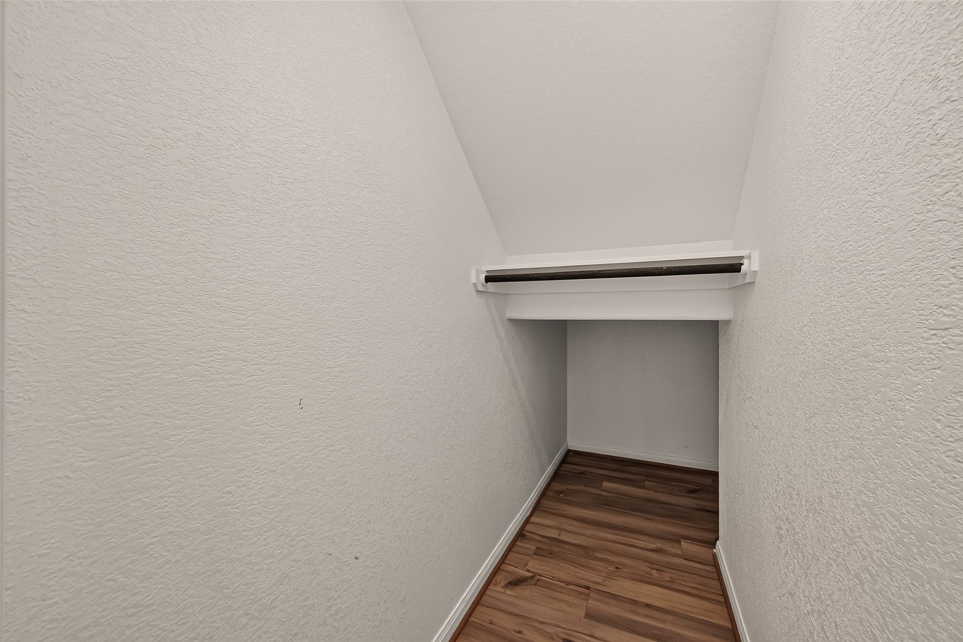 Discover smart under-staircase storage with ample space and a handy rack for your cherished items.